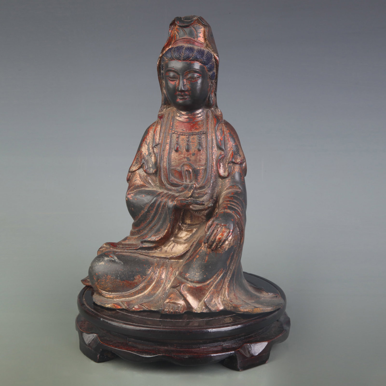 A GILT BRONZE SEATED FIGURE OF GUANYIN: 20th Century; Width: 7.2 inch; High: 9.0 inch; Wooden base for picture and display only.