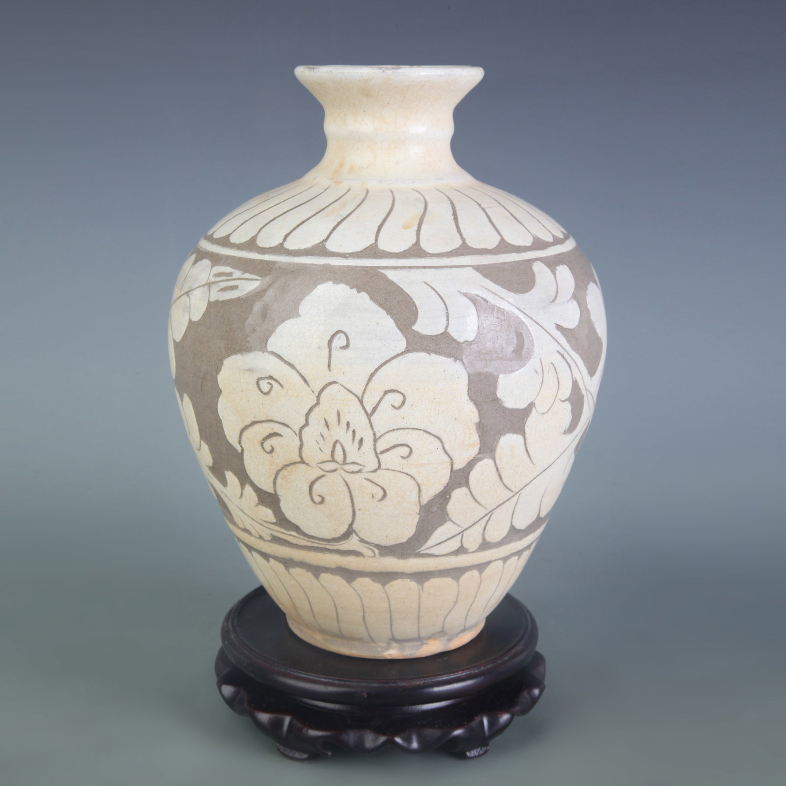 A CIZHOU KILN JAR WITH WHITE FLORAL DECORATION ON BROWN GROUND: Yuan Dynasty Style; Diameter: 2.6 inch; High: 8.1 inch; Wooden base for picture and display only.