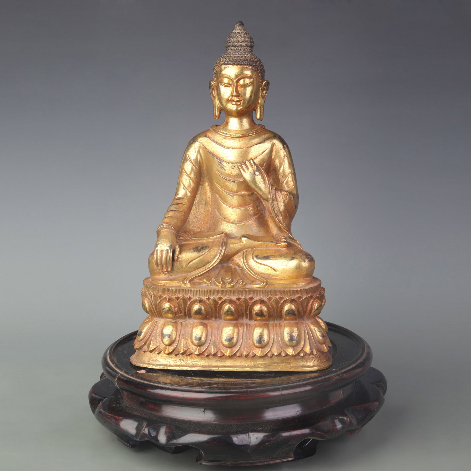 A FINE TIBETAN BUDDHIST BRONZE STATUE: Qing Dynasty; Width: 6.6 inch; High: 10.9 inch. Wooden base for picture and display only.