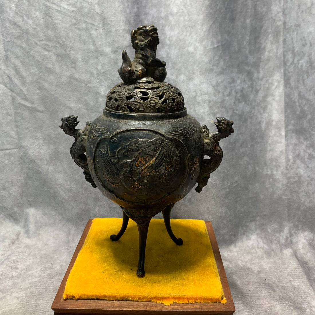 QIAN LONG MARK BRONZE PHOENIX PATTERN THREE-LION FOOT DRAGON EAR CENSER: Qing Dynasty; High: 9.2 inch; Diameter: 6.6 inch. Wooden base for picture and display only.