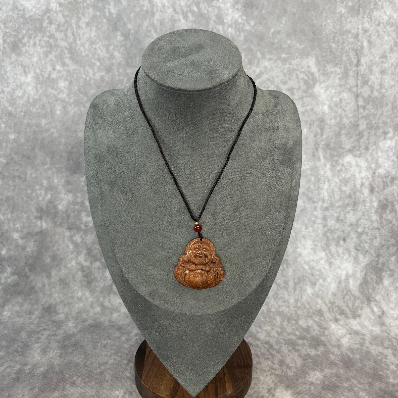 A FINE ROSEWOOD CARVING LAUGHING BUDDHA NECKLACE: Modern; Long: 1.6 inch; Width: 1.5 inch; High: 0.38 inch.