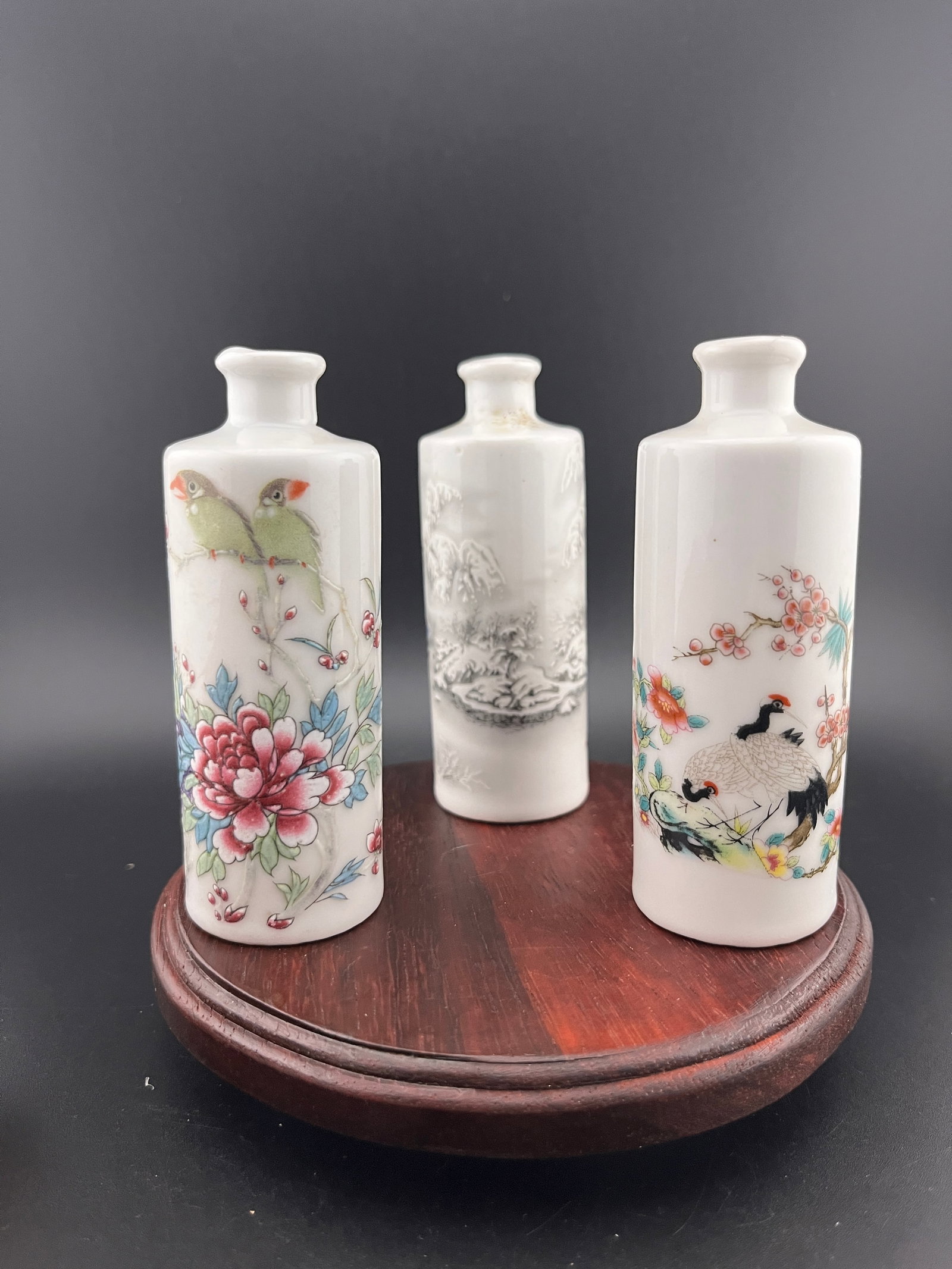 GROUP OF THREE FAMILLE ROSE PORCELAIN SNUFF BOTTLE: Modern; High: 3.8 inch; Diameter: 1.4 inch. Wooden base for picture and display only.