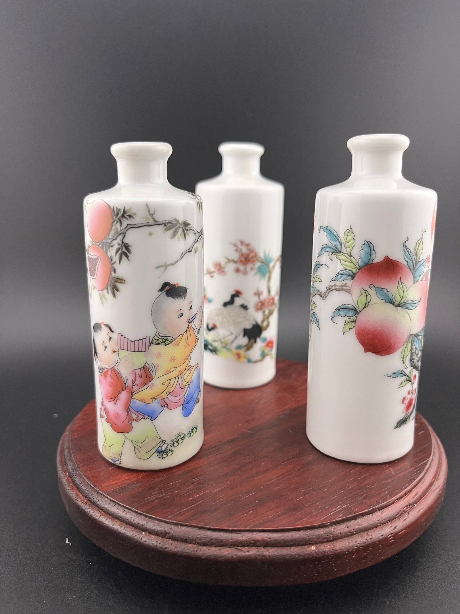 GROUP OF THREE FAMILLE ROSE PORCELAIN SNUFF BOTTLE: Modern; High: 3.69 inch; Diameter: 1.35 inch; High: 3.73 inch; Diameter: 1.39 inch; High: 3.8 inch; Diameter: 1.39 inch. Wooden base for picture and display only.