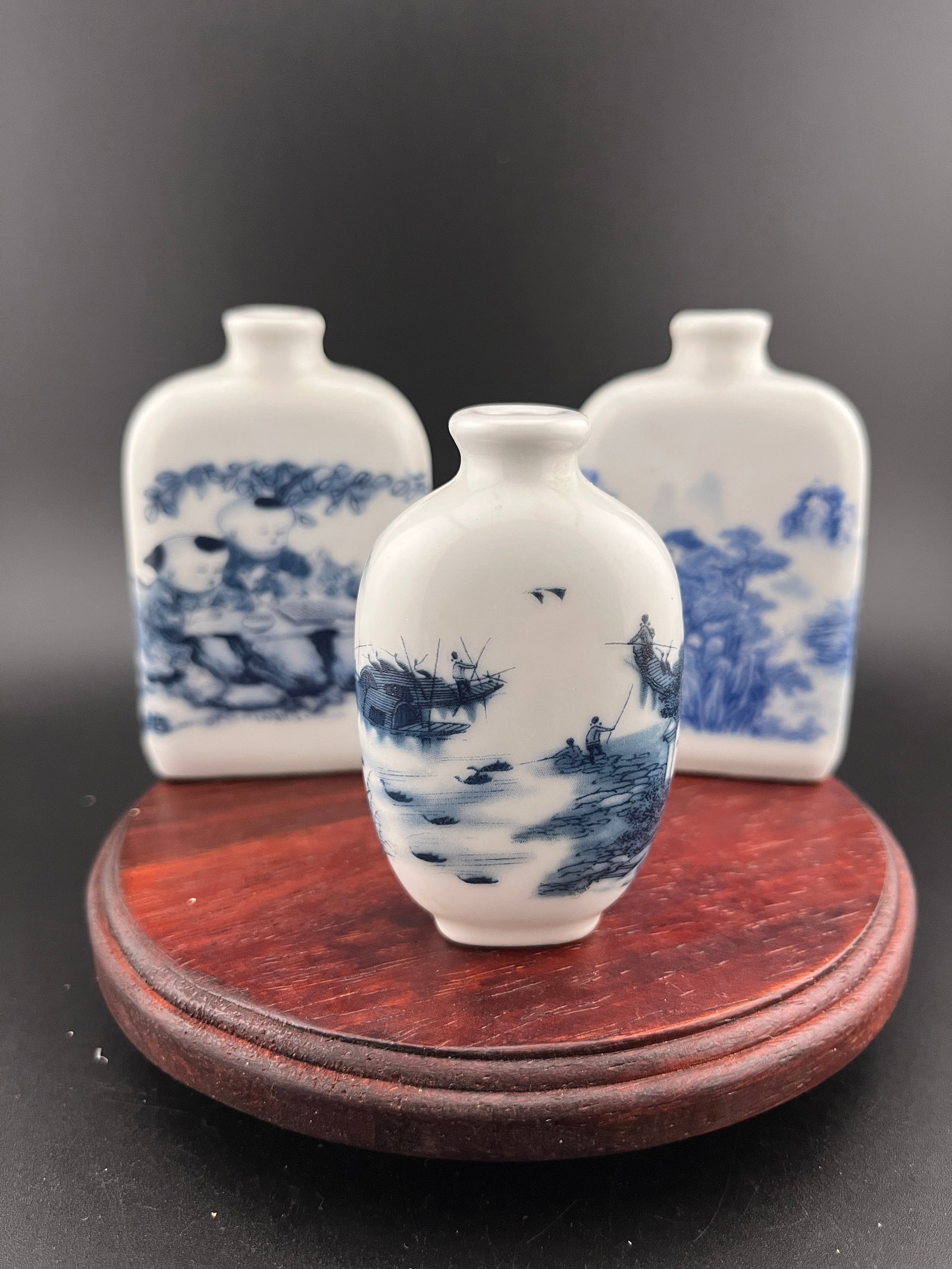 GROUP OF THREE FAMILLE ROSE PORCELAIN SNUFF BOTTLE: Modern; Long: 2.1 inch; Width: 0.87 inch; High: 3.1 inch; Long: 2.1 inch; Width: 0.87 inch; High: 3.1 inch; Long: 1.65 inch; Width: 1.1 inch; High: 2.74 inch. Wooden base for picture and display only.