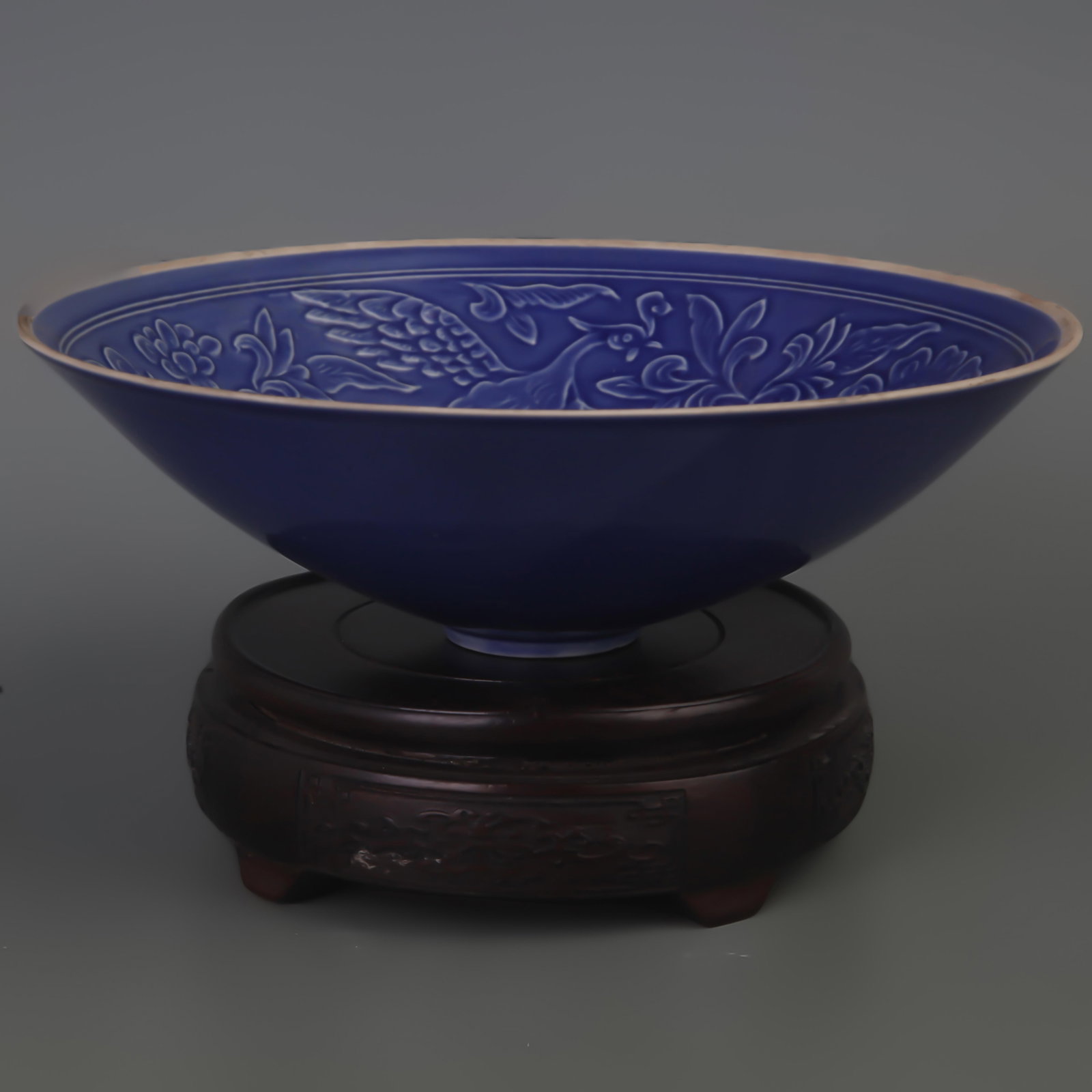 A DARK BLUE FLOWER PATTERN CARVING PORCELAIN PLATE: Song Dynasty Style; Diameter:8.3 inch; High: 2.7 inch. Wooden base for picture and display only.