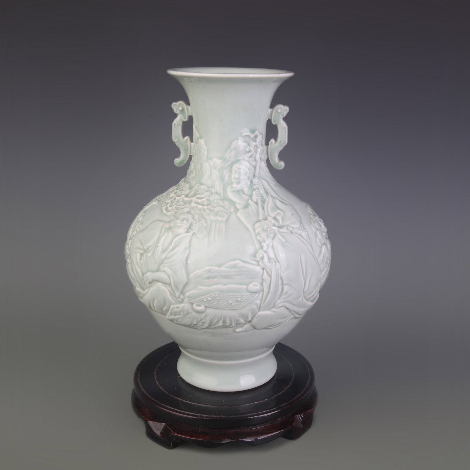 CELADON GLAZED HUMAN FIGURE PATTERN DOUBLE-EAR PORCELAIN VASE: Qing Dynasty Qian Long Period; Diameter: 4.2 inch; High: 10.9 inch; Wooden base for picture and display only.