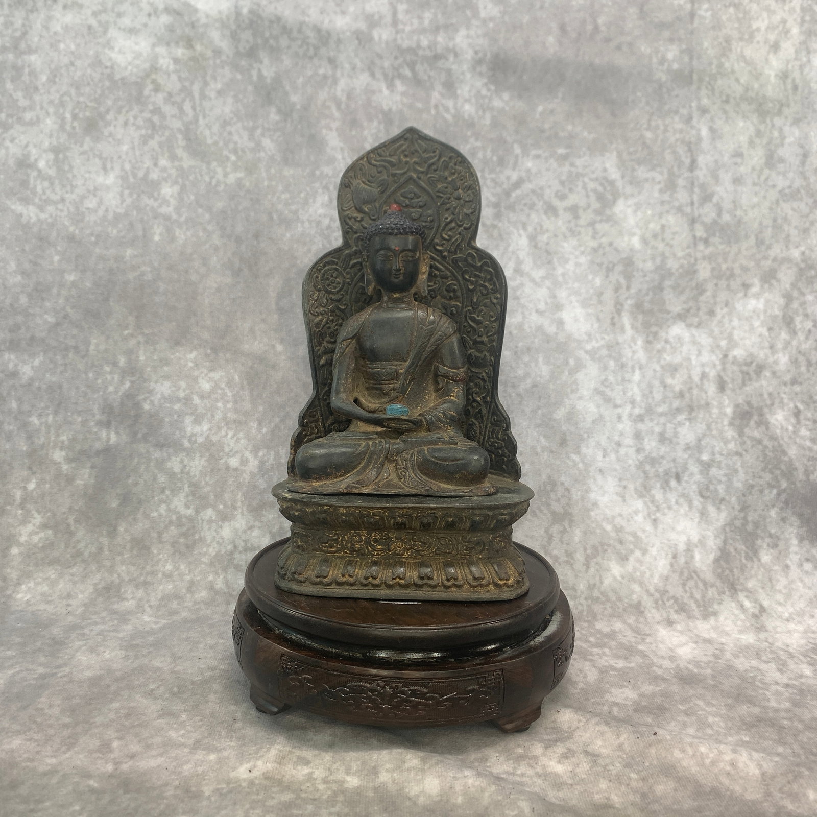 A FINE BRONZE MEDICINE BUDDHA WITH MANDORLA: Qing Dynasty; Long: 4.9 inch; Width: 3.6 inch; High: 8.9 inch. Wooden base for picture and display only.