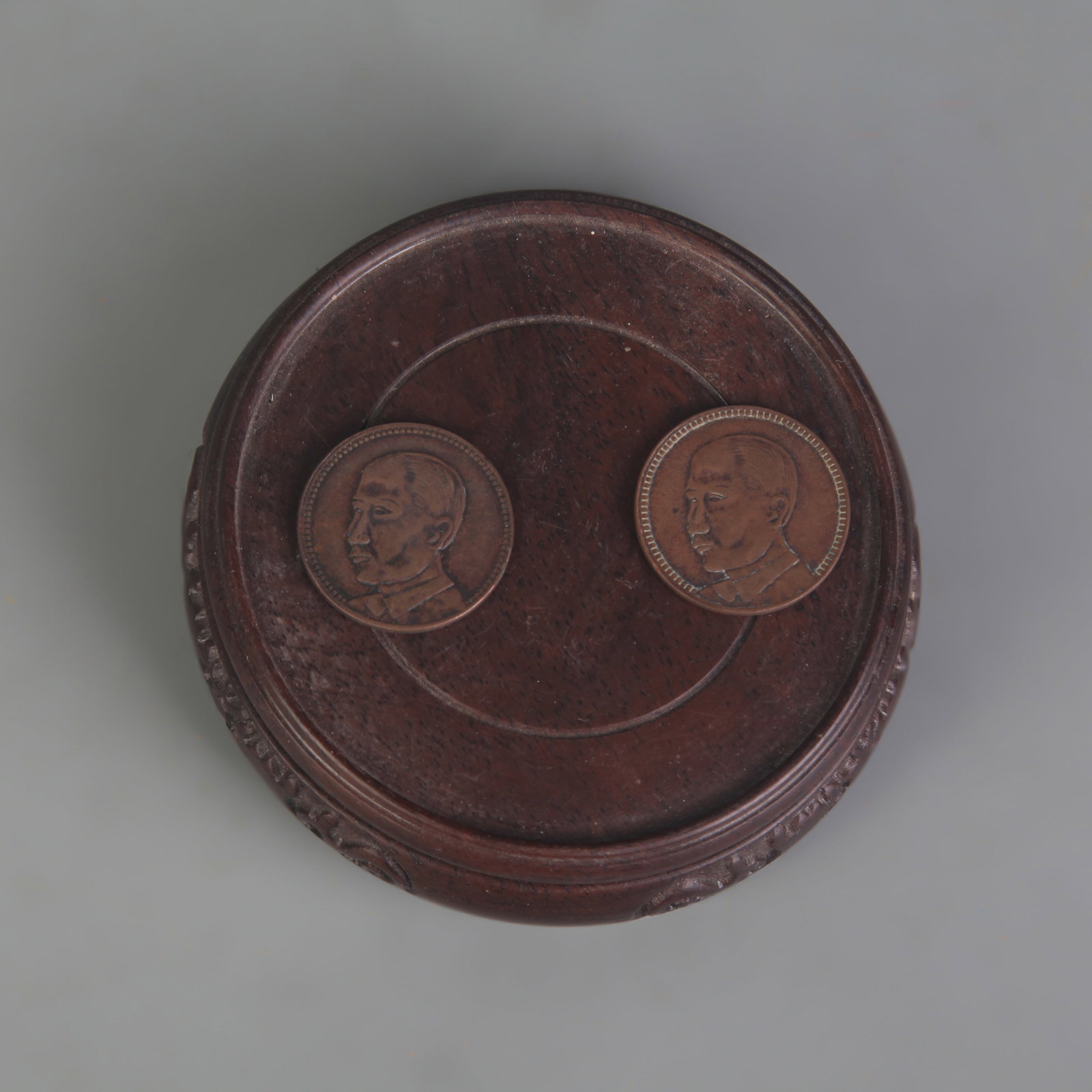 A PAIR OF GUANGDONG ONE-CENT COINS: Republic Period; Diameter: 1.0 inch; Wooden base for picture and display only.