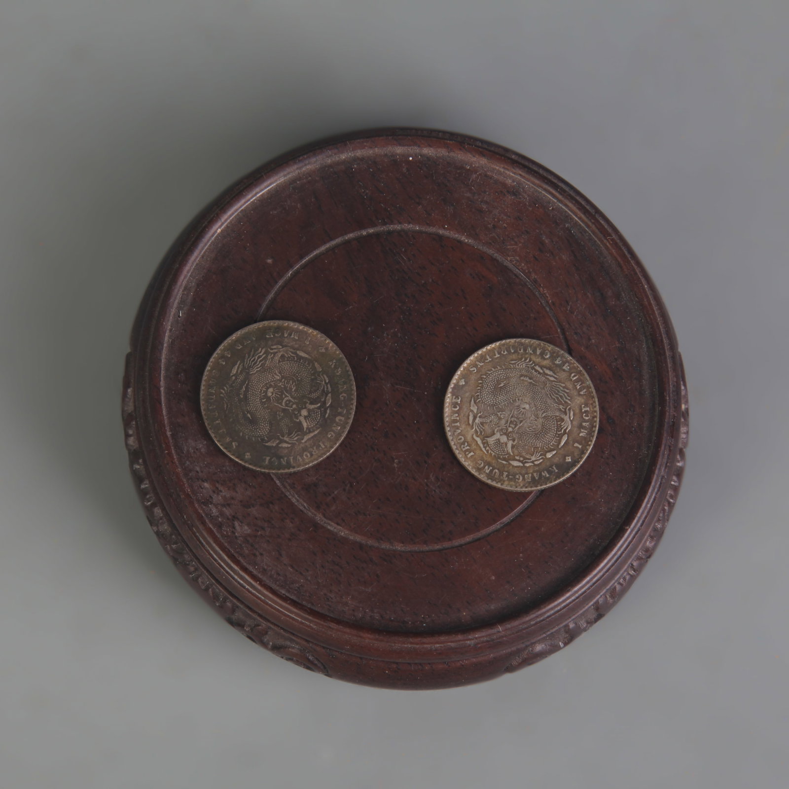 TWO COINS: GUANGXU YUANBAO AND XUANTONG YUANBAO: Republic Period; Diameter: 0.9 inch; Wooden base for picture and display only.