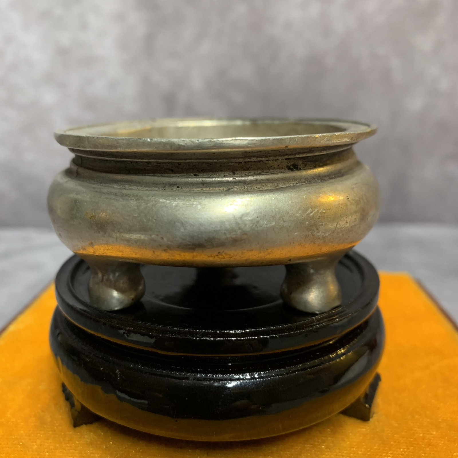 A FINE WHITE BRONZE TRIPOD CENSER: Qing Dynasty; High: 1.4 inch; Diameter: 2.9 inch; Wooden base for picture and display only.