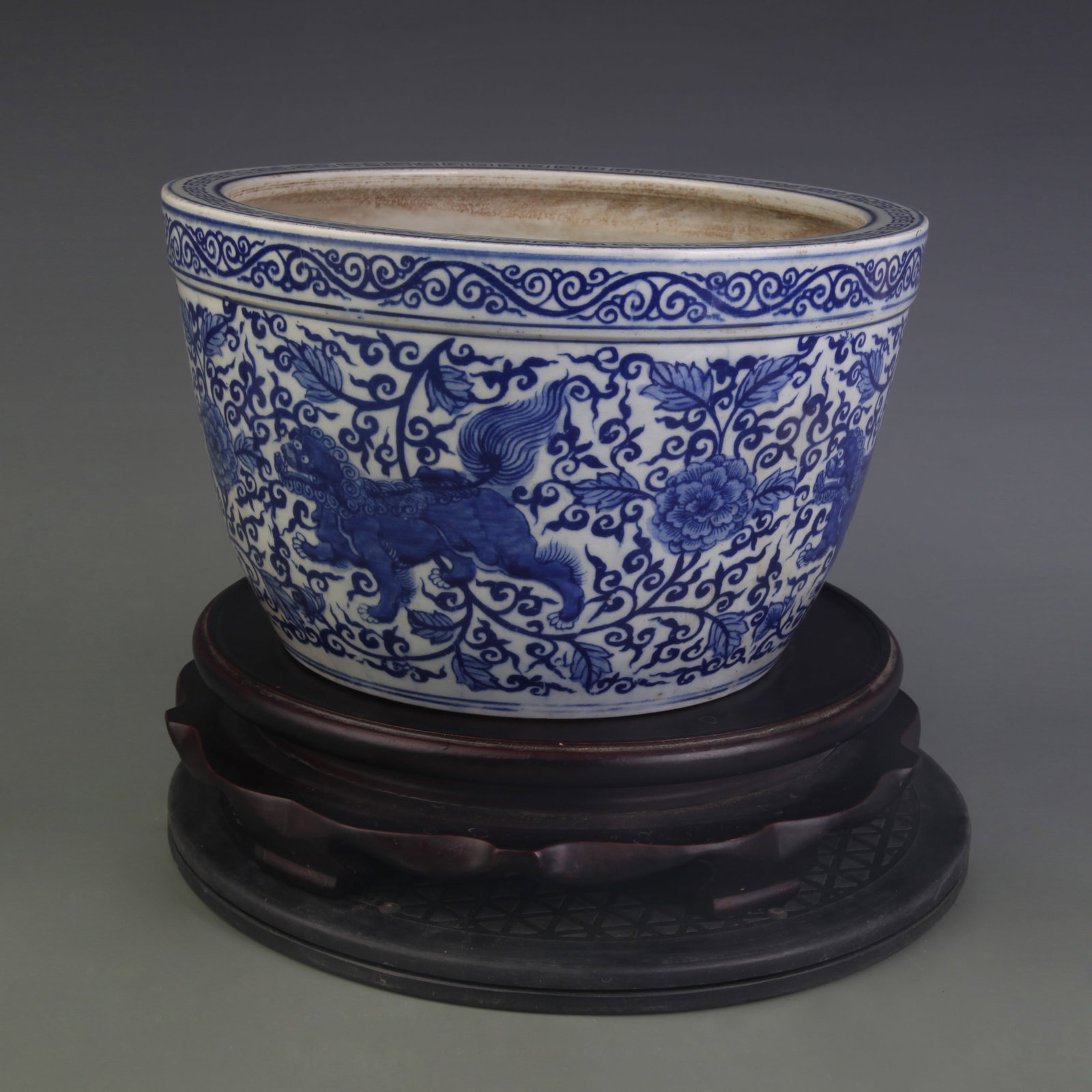 A BLUE-AND-WHITE ‘AUSPICIOUS BEASTS AND FLORAL’ ROLLED-RIM PORCELAIN JAR: Ming Dynasty Style Wan Li Period; Diameter: 10.7 inch; High: 6.3 inch; Wooden base for picture and display only.