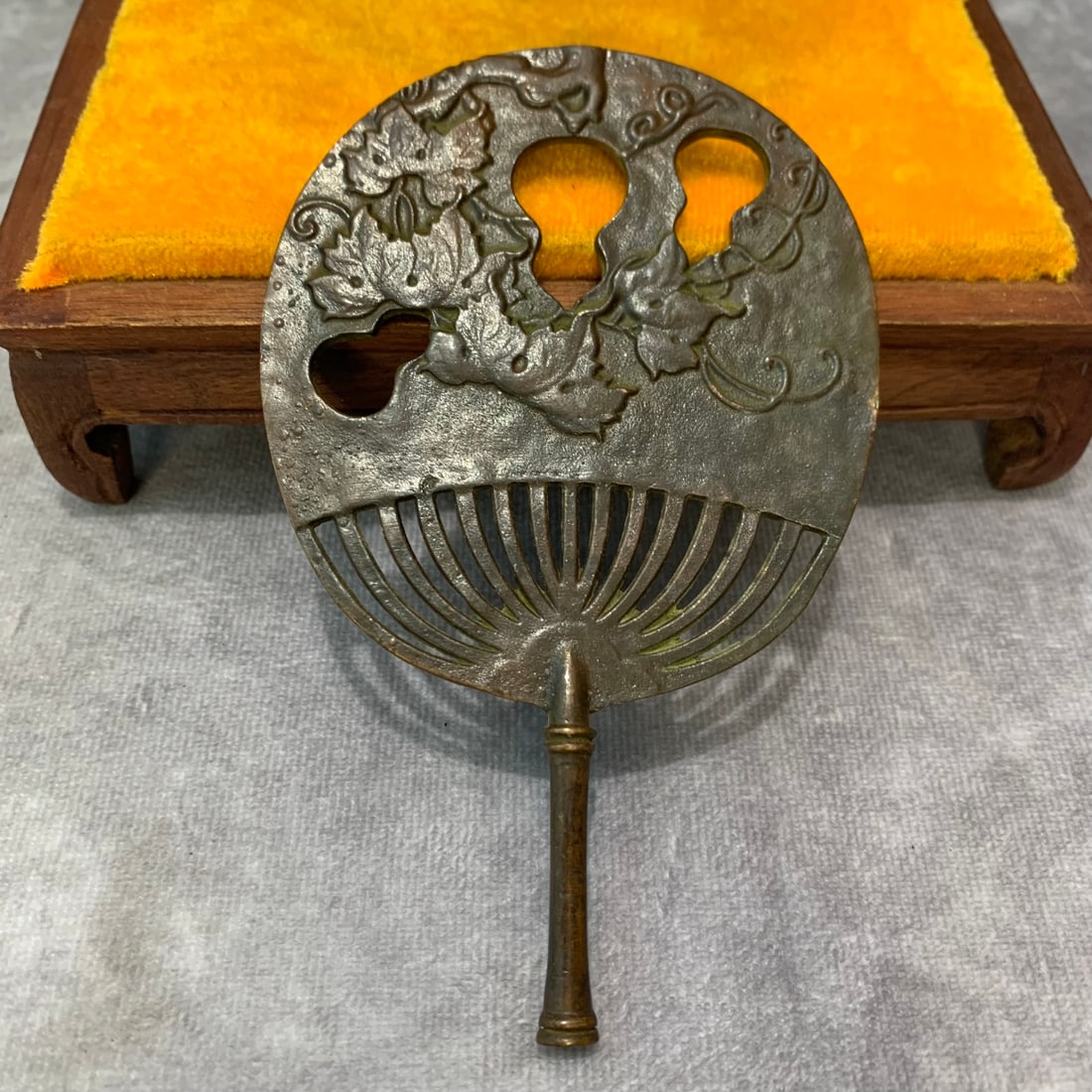 A SMALL ANTIQUE JAPANESE BRONZE FAN: Meiji Period; High: 5.2 inch; Width: 3.3 inch; Wooden base for picture and display only.