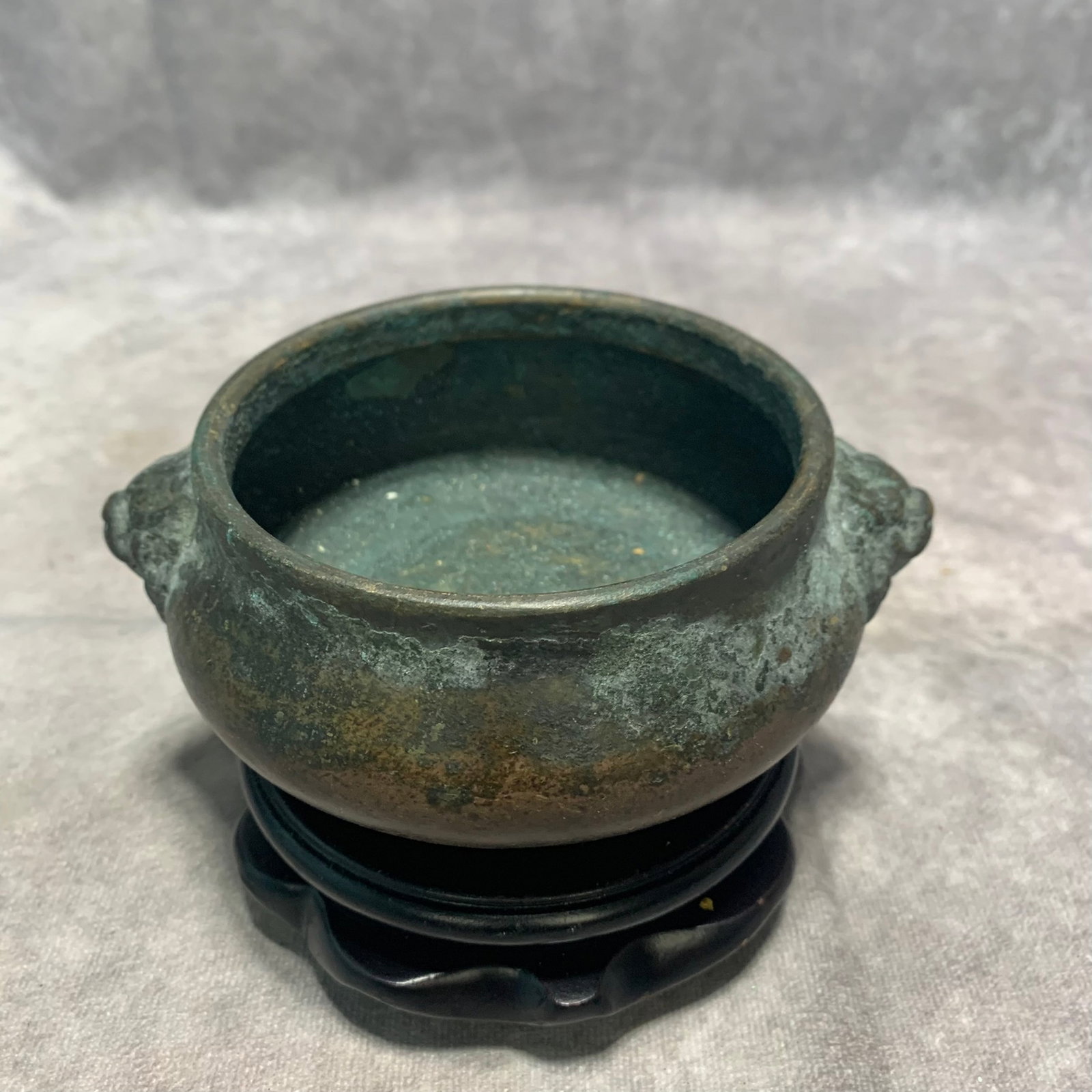 XUAN DE MARKED BRONZE LION-EAR CENSER: Ming Dynasty; High: 2.1 inch; Diameter: 5.5 inch; Wooden base for picture and display only.