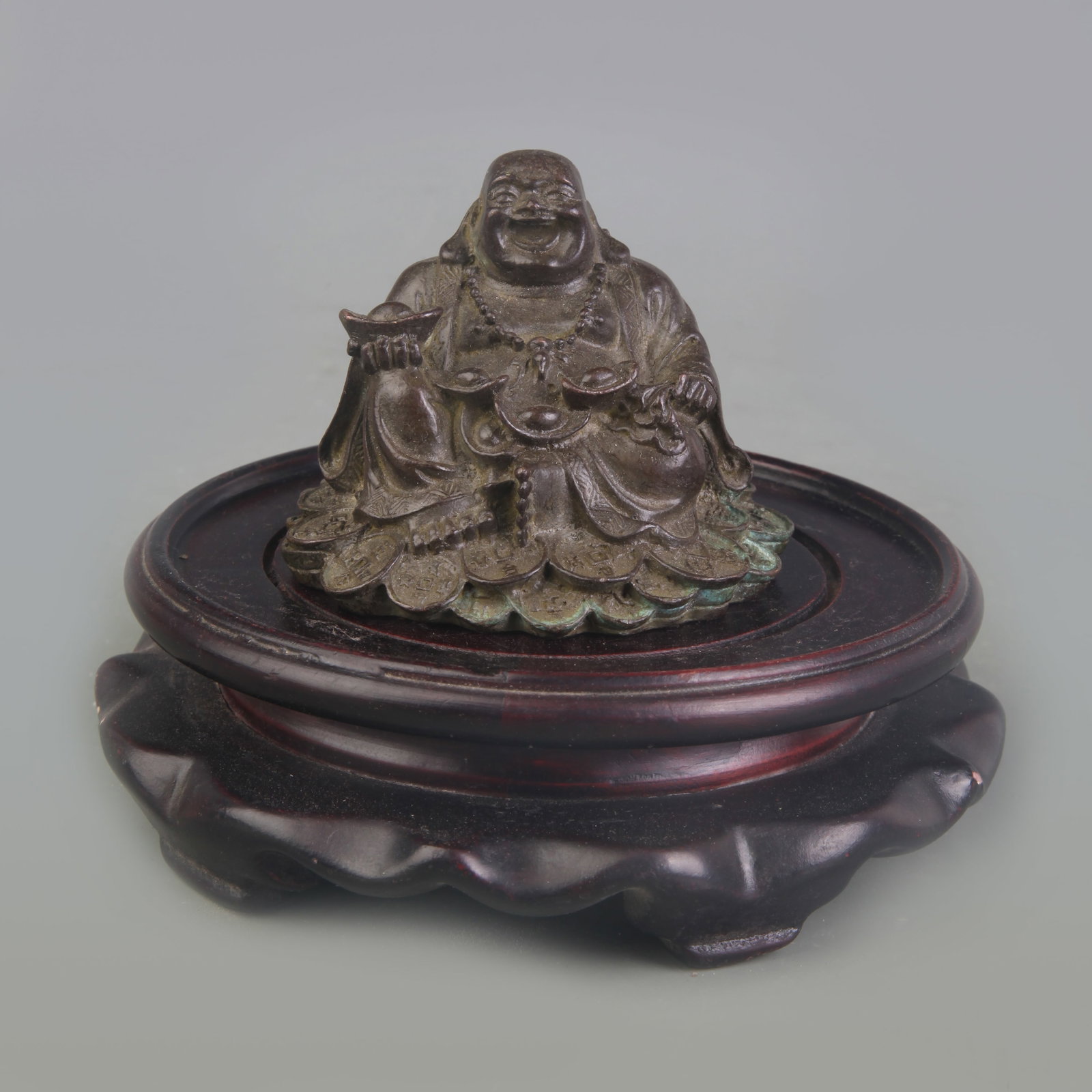 A FINE SMALL BRONZE FIGURE OF LAUGHING BUDDHA: Qing Dynasty; Width: 3.0 inch; High: 2.3 inch; Wooden base for picture and display only.
