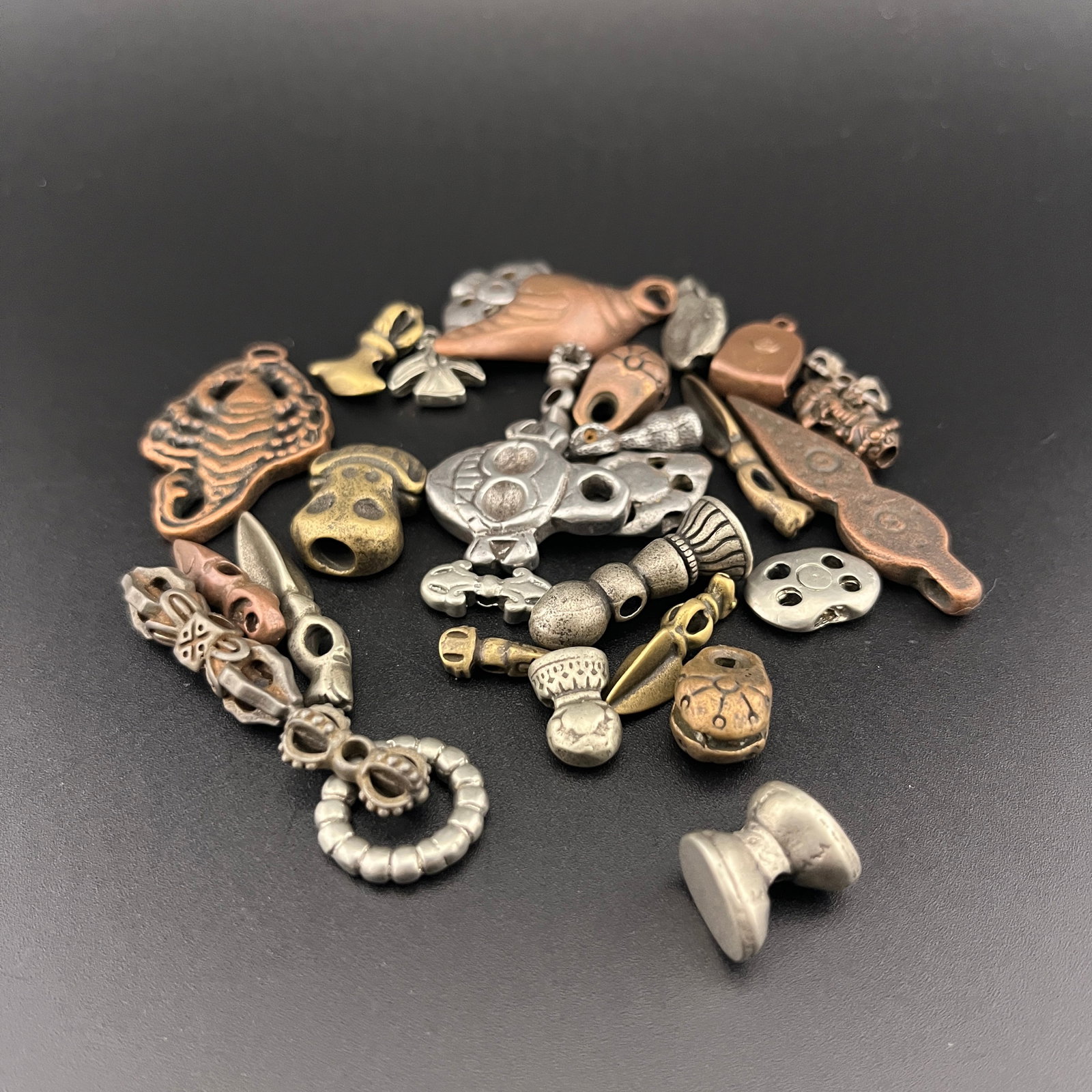 GROUP OF SMALL TIBETAN BUDDHISM RITUAL CHARMS AND BEADS: Modern; Long: 0.48 inch to 1.5 inch; Width: 0.32 inch to 0.92 inch; High: 0.18 inch to 0.22 inch