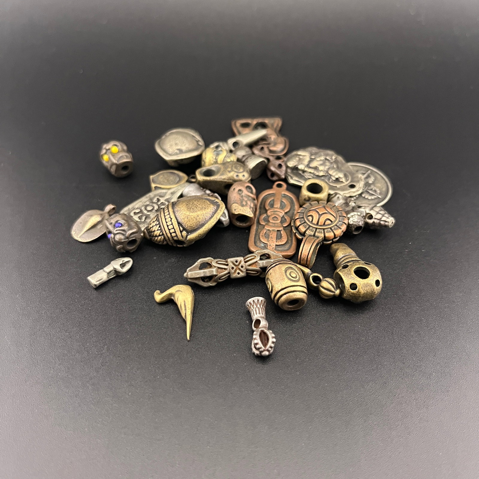 GROUP OF SMALL TIBETAN BUDDHISM RITUAL CHARMS AND BEADS (1 of 3)