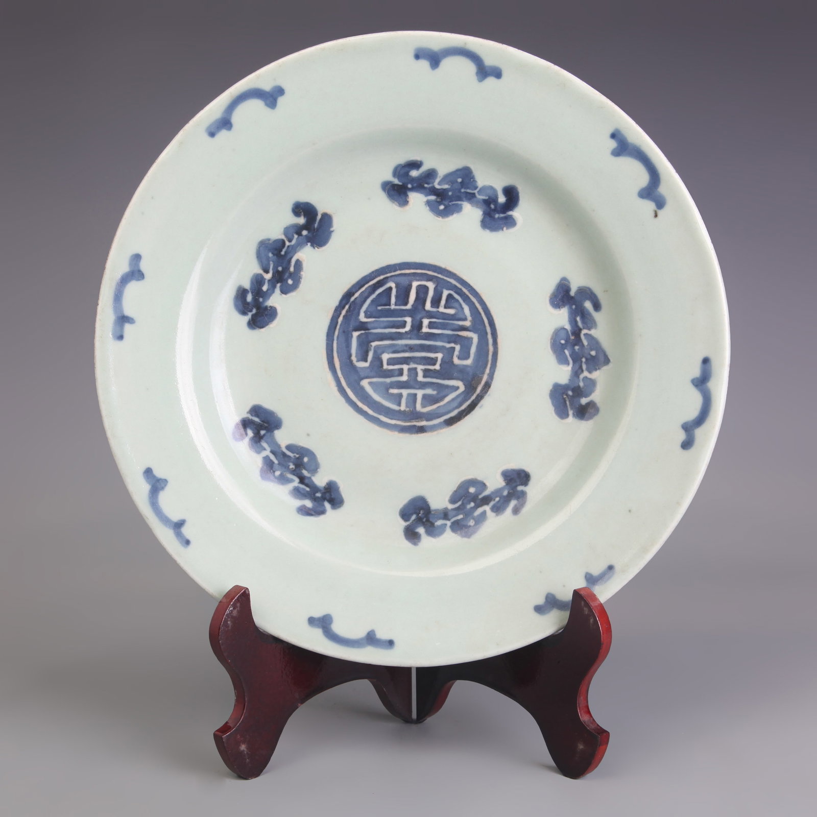 A CELADON-GLAZED ‘FU AND SHOU’ PORCELAIN DISH: Ming Dynasty Style Cheng Hua Period; Diameter: 10.4 inch; High: 1.6 inch; Wooden base for picture and display only.
