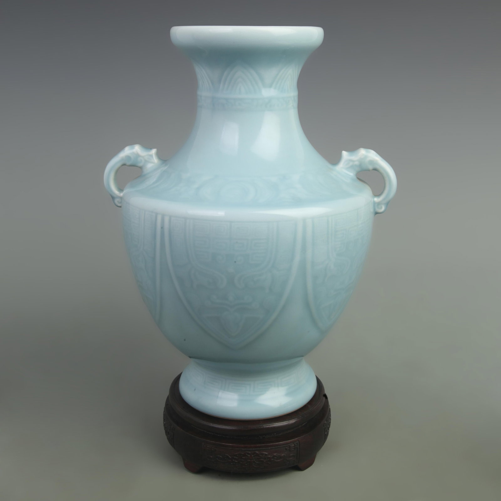 A CELADON-GLAZED TWIN-HANDLED VASE WITH INCISED ANIMAL MASK MOTIFS (1 of 5)