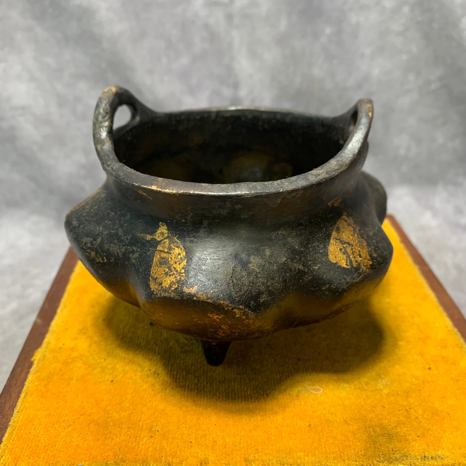 GILT BRONZE THREE-LEGGED EARED QUATREFOIL CENSER: Qing Dynasty; High: 2.2 inch; Diameter: 4.3 inch; Wooden base for picture and display only.