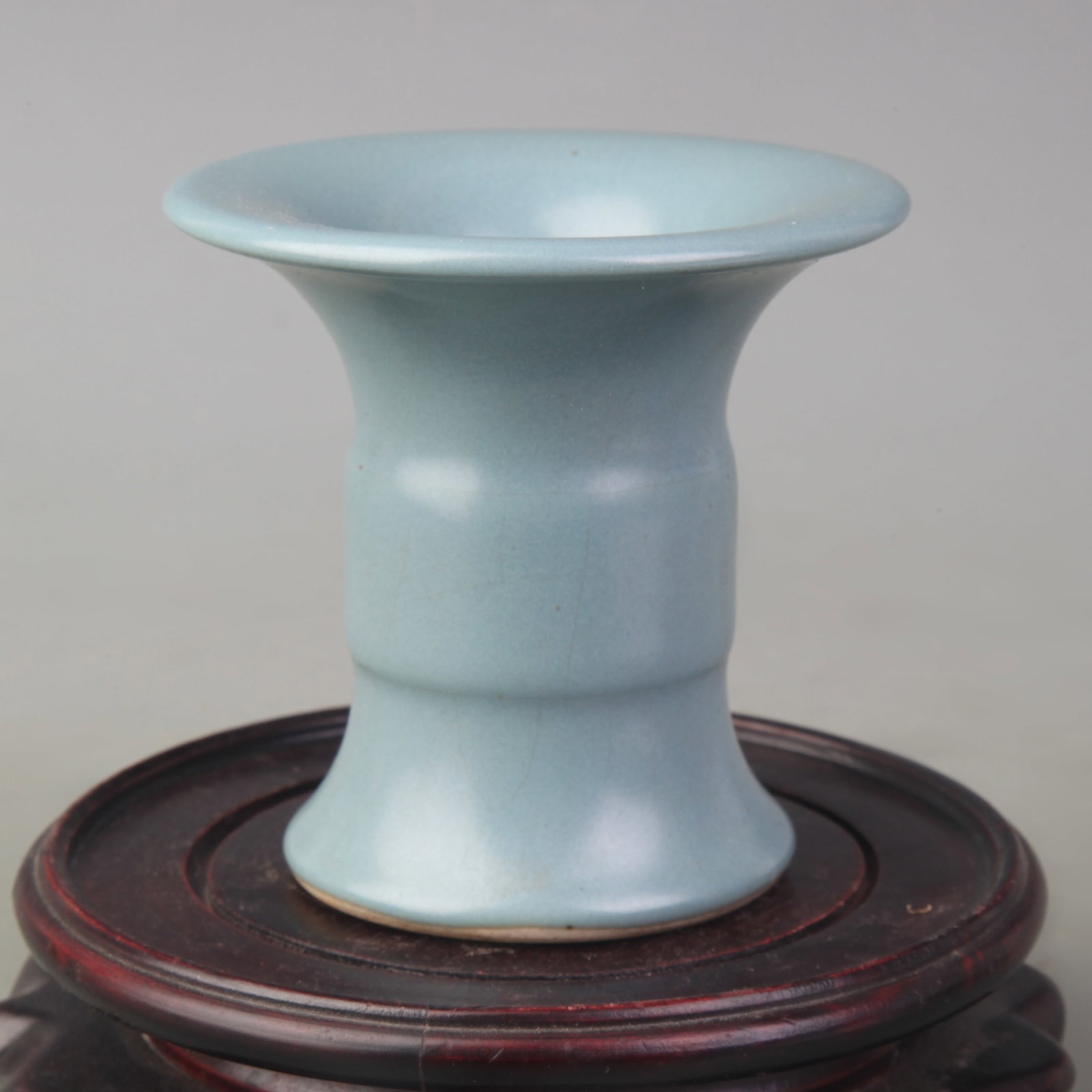 SMALL CELADON-GLAZED PORCELAIN GU VASE: Ming Dynasty Style; Diameter: 3.3 inch; High: 3.2 inch; Wooden base for picture and display only.
