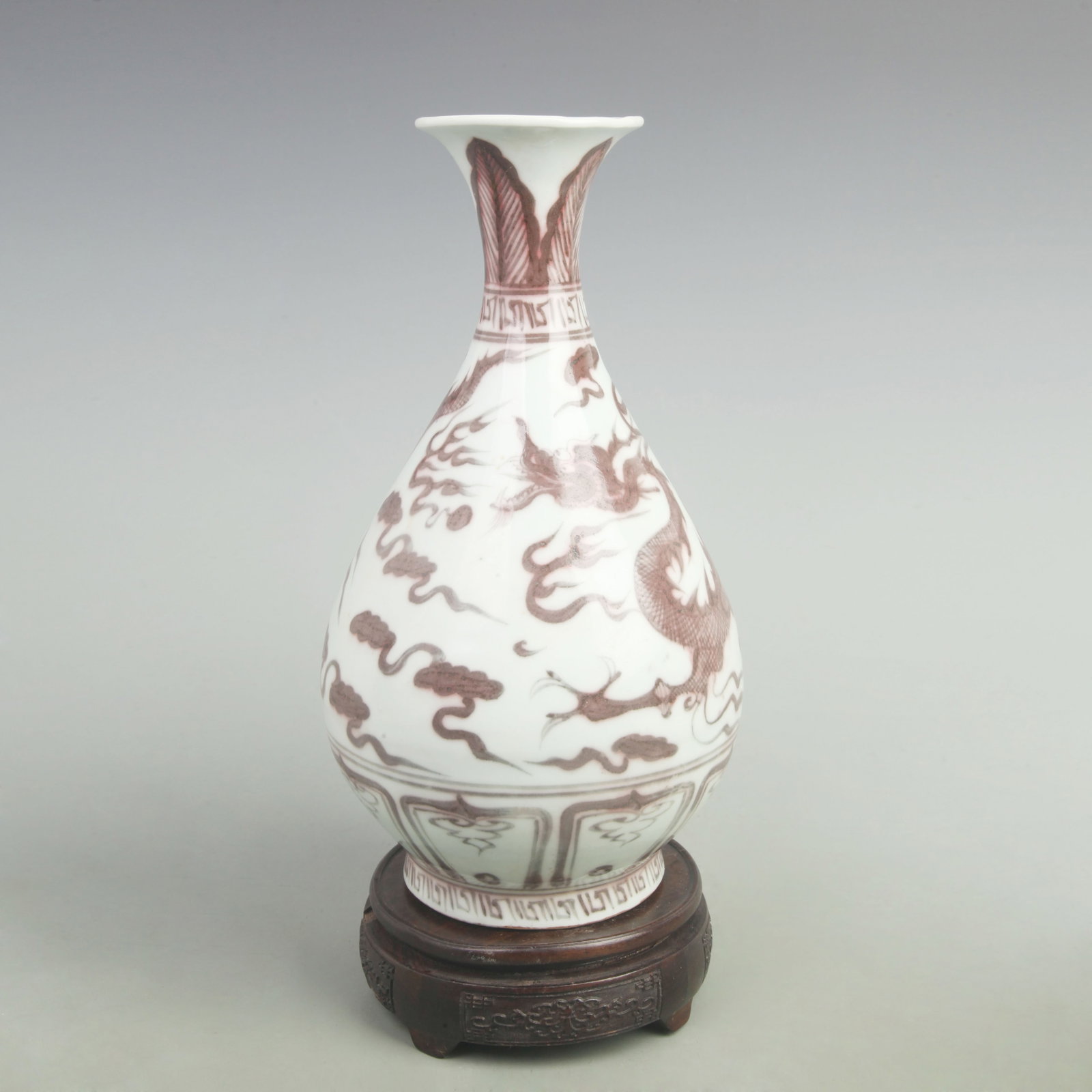 AN UNDERGLAZE RED YUHUCHUN VASE WITH DRAGON MOTIF: Yuan Dynasty Style; High: 11.8 inch; Width: 6.5 inch; Wooden base for picture and display only.