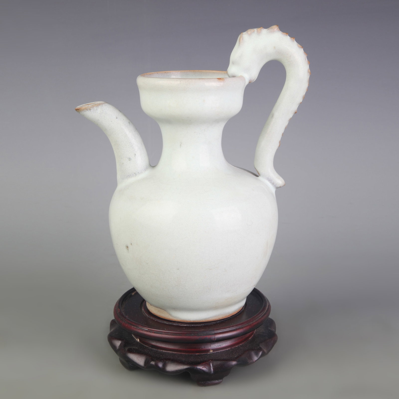 A FINE CELADON GLAZED POECELAIN EWER: Ming Dynasty Style; Width: 7.0 inch; High: 8.3 inch; Wooden base for picture and display only.