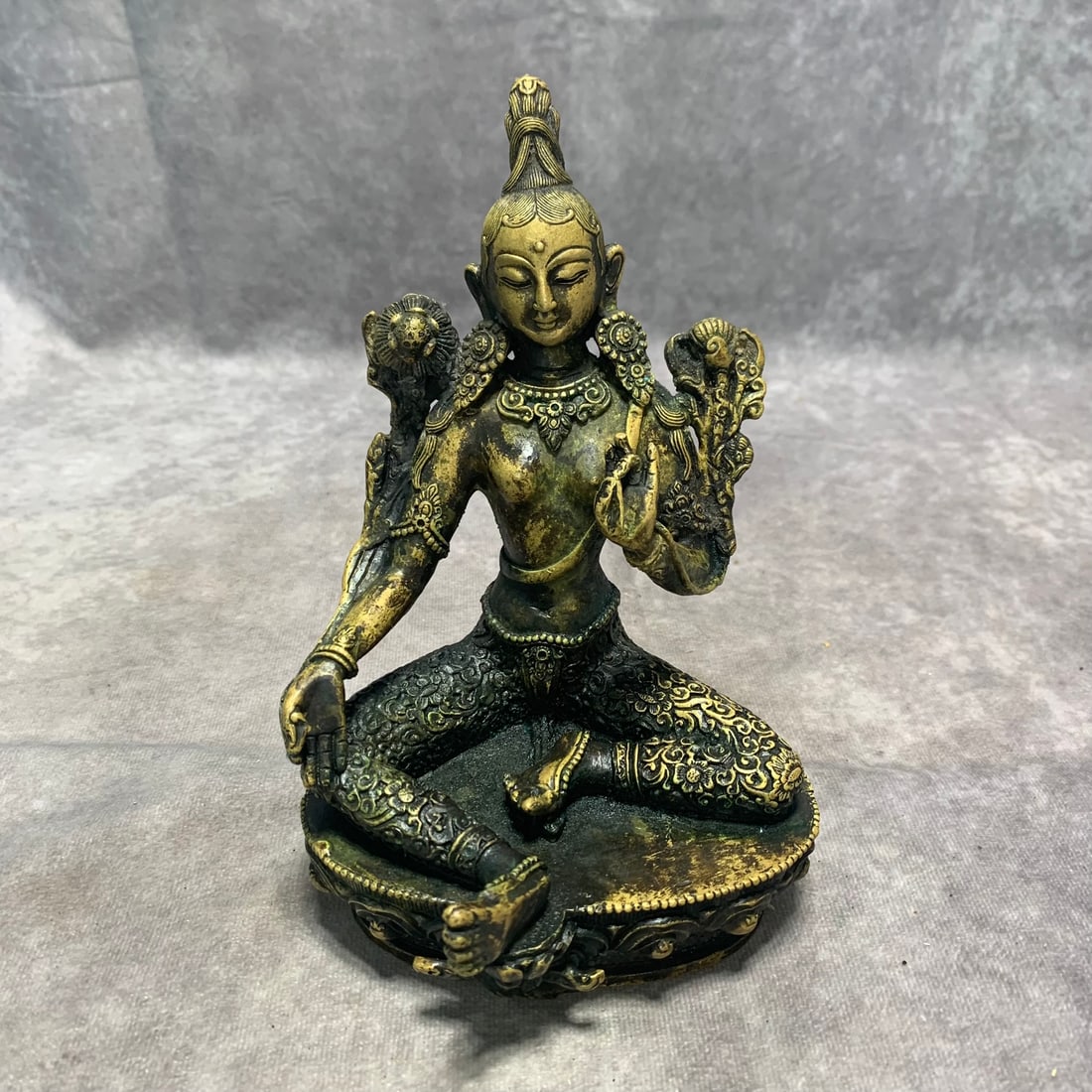 A FINE TIBETAN GILT BRONZE TARA: Qing Dynasty; Long: 4.7 inch; Width: 4.5 inch; High: 7.1 inch. Wooden base for picture and display only.