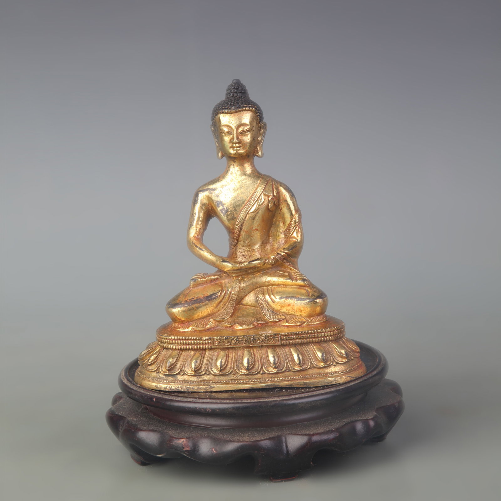 GILT BRONZE SHAKYAMUNI BUDDHA STATUE: Qing Dynasty Qian Long Period; Width: 4.4 inch; High: 5.4 inch. Wooden base for picture and display only.