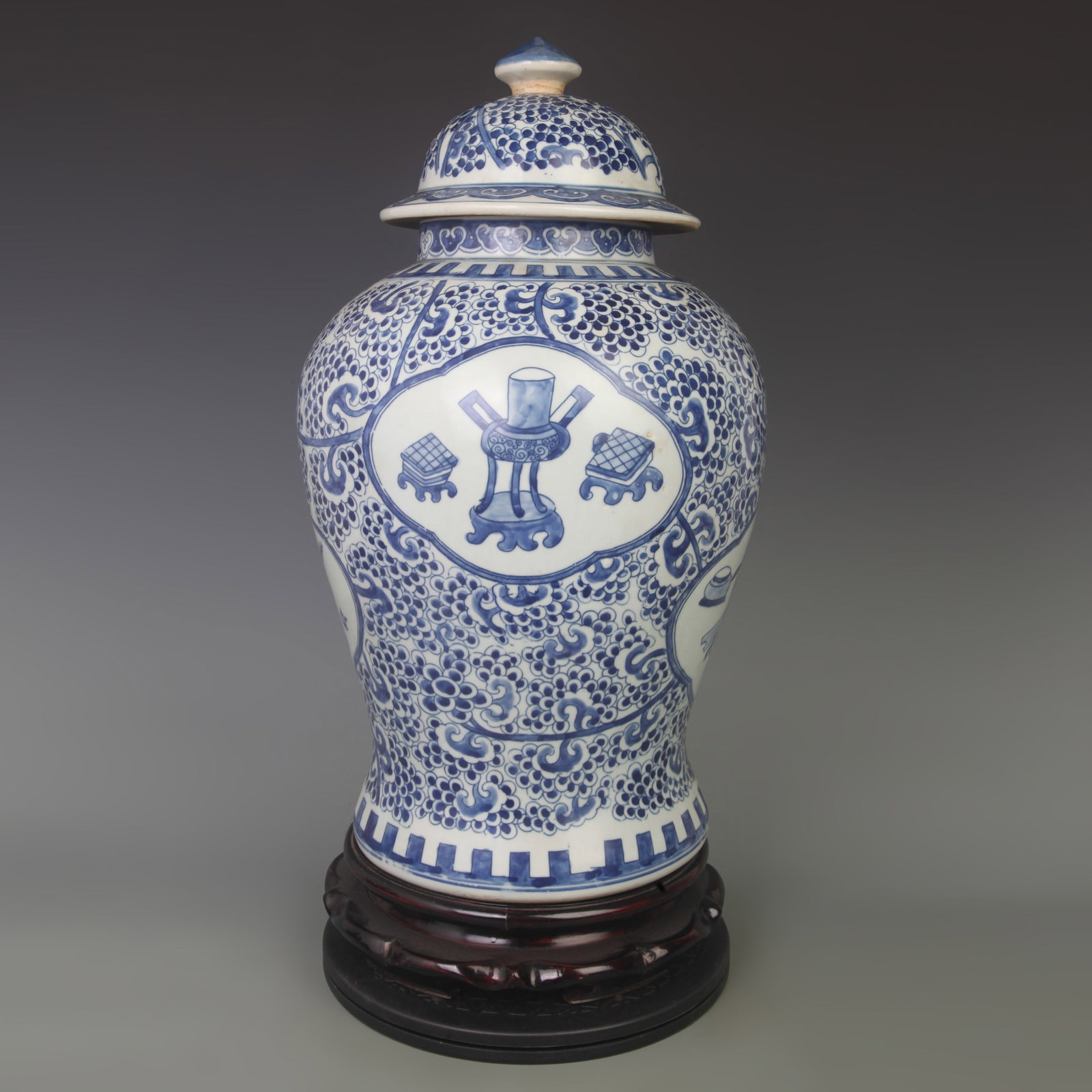 BLUE AND WHITE GLAZED OPENWORK EIGHT TREASURES GENERAL STYLE PORCELAIN JAR: Qing Dynasty; High:19.5 inch; Diameter: 5.6 inch; Wooden base for picture and display only.