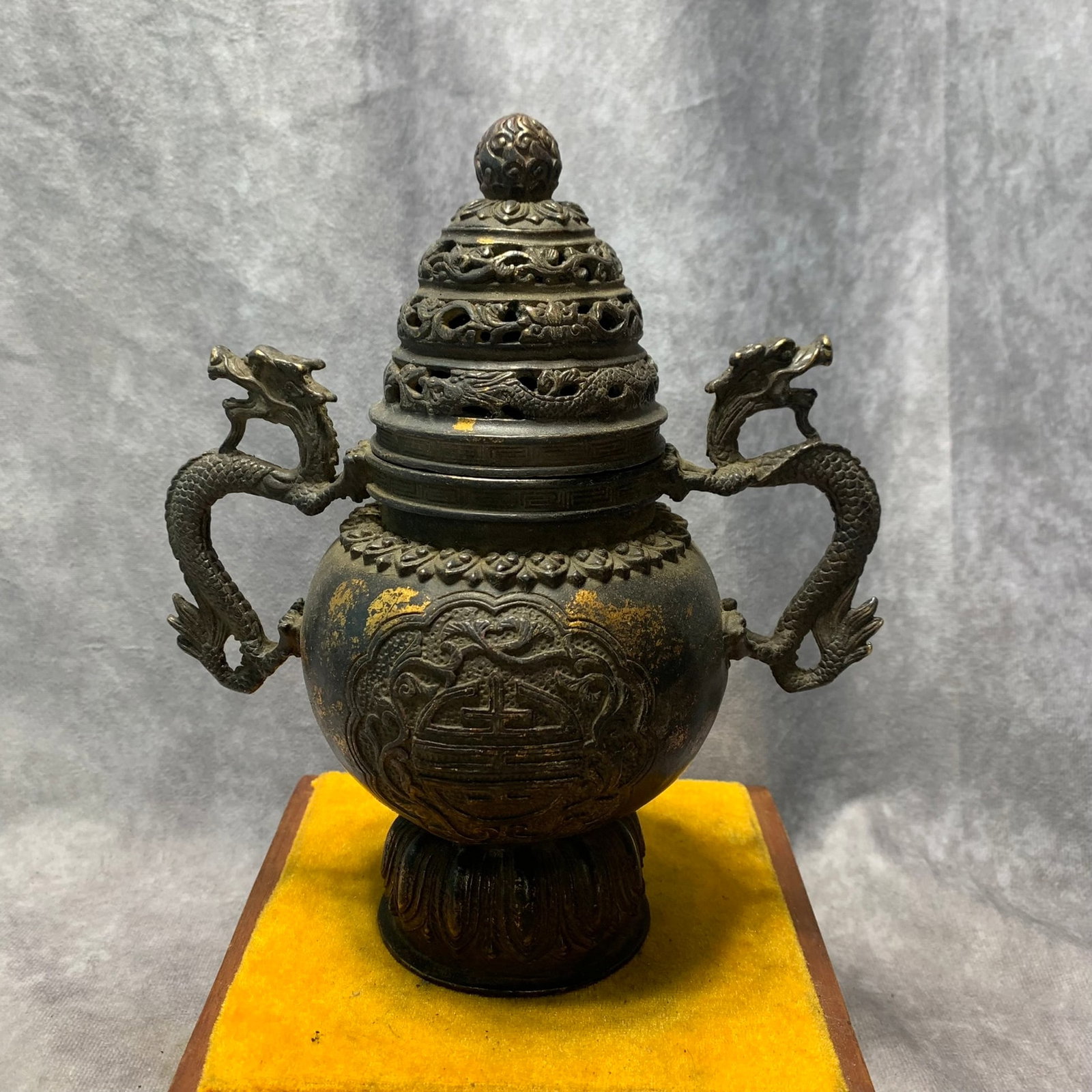 QIANLONG ERA TOWER-STYLE INCENSE BURNER WITH LONGEVITY SYMBOLS AND DRAGON HANDLES: Qing Dynasty; High: 8.1 inch; Diameter: 7.2 inch. Wooden base for picture and display only.