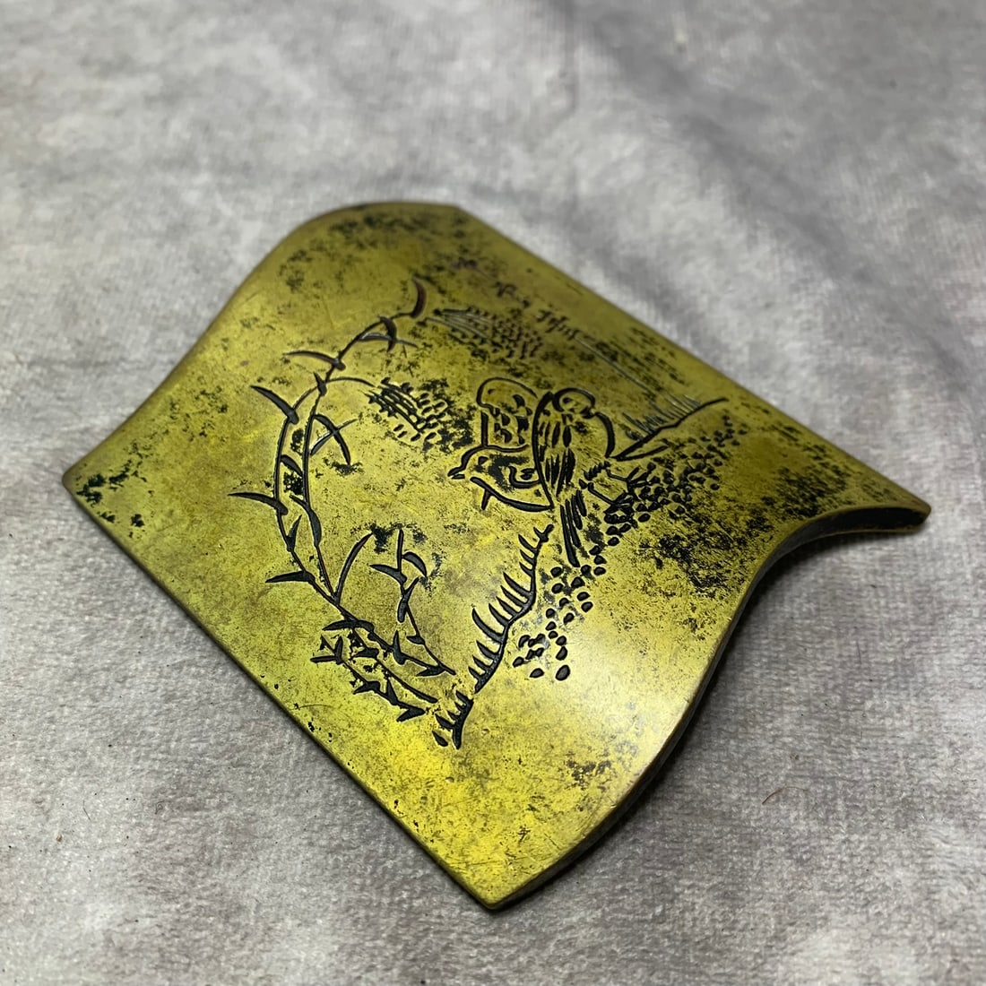 BRONZE ARMREST ENGRAVED WITH FLORAL, BIRD, AND POETIC INSCRIPTIONS: Republic Period; Long: 3.7 inch; Width: 3 inch; High: 0.2 inch. Wooden base for picture and display only.
