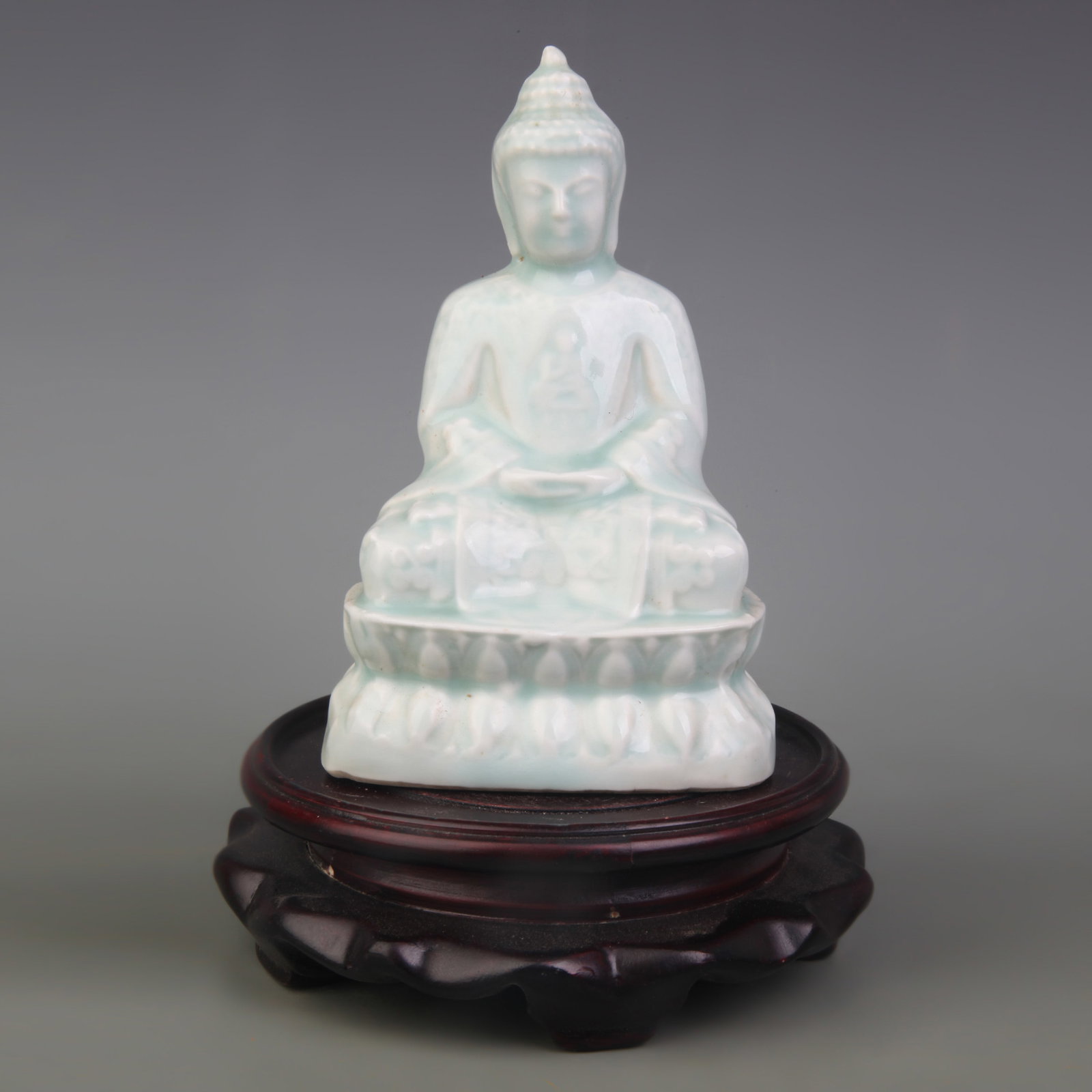 LIGHT BLUE COLOR GLAZE PORCELAIN SHAKYAMUNI STATUE: Qing Dynasty; High:5.3 inch. Wooden base for picture and display only.