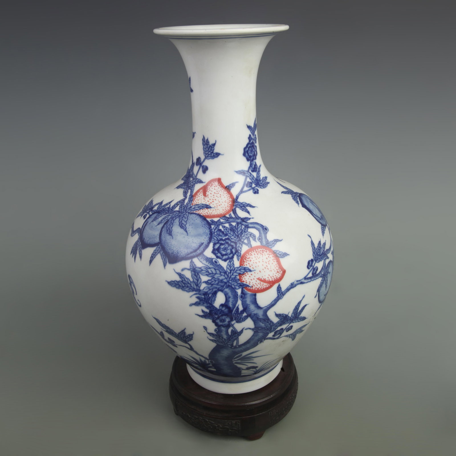 BLUE AND WHITE PORCELAIN VASE WITH UNDERGLAZE RED NINE PEACHES PATTERN: Qing Dynasty Yong Zheng Period, High: 13.5 inch; Width: 9.5 inch. Wooden base for picture and display only.