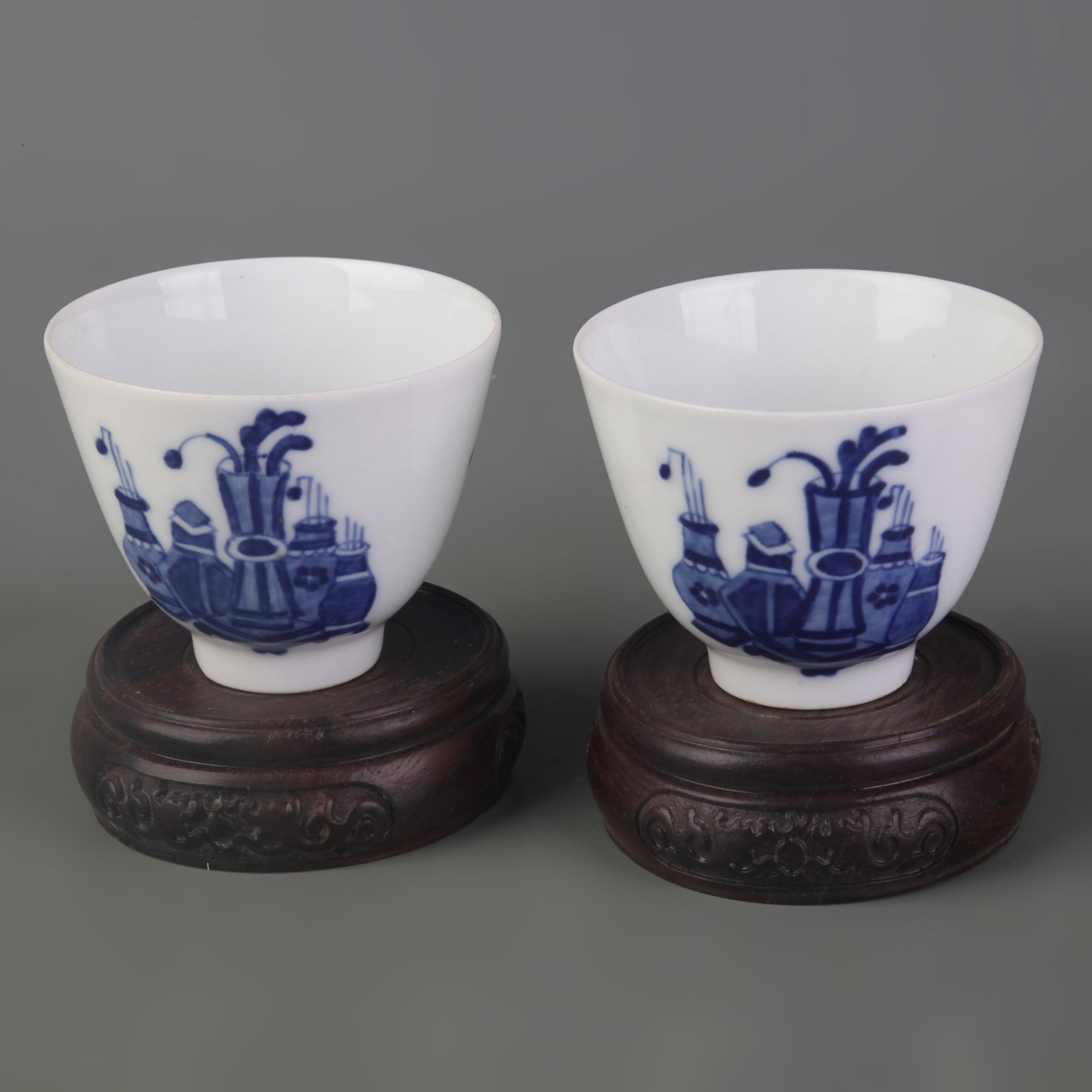 PAIR OF BLUE AND WHITE FLORAL PATTERN SMALL CUPS: Qing Dynasty; Diameter: 2.9 inch; High: 2.3 inch; Wooden base for picture and display only.