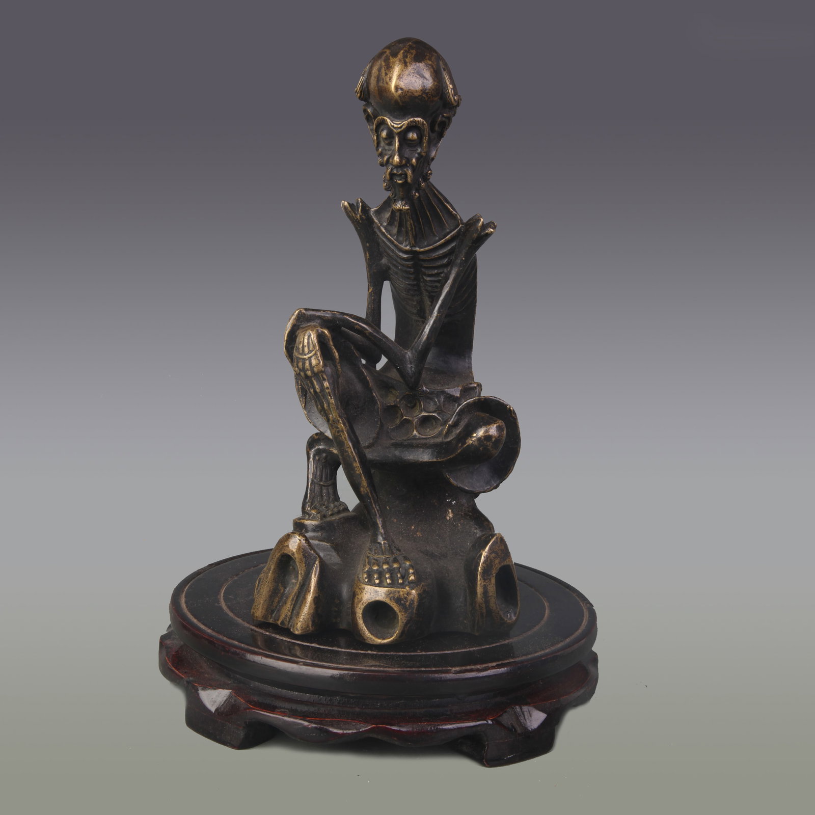 A FINE BRONZE SKINNY-LIMBED ARHAT STATUE: Qing Dynasty; High: 8.5 inch; Wooden base for picture and display only.