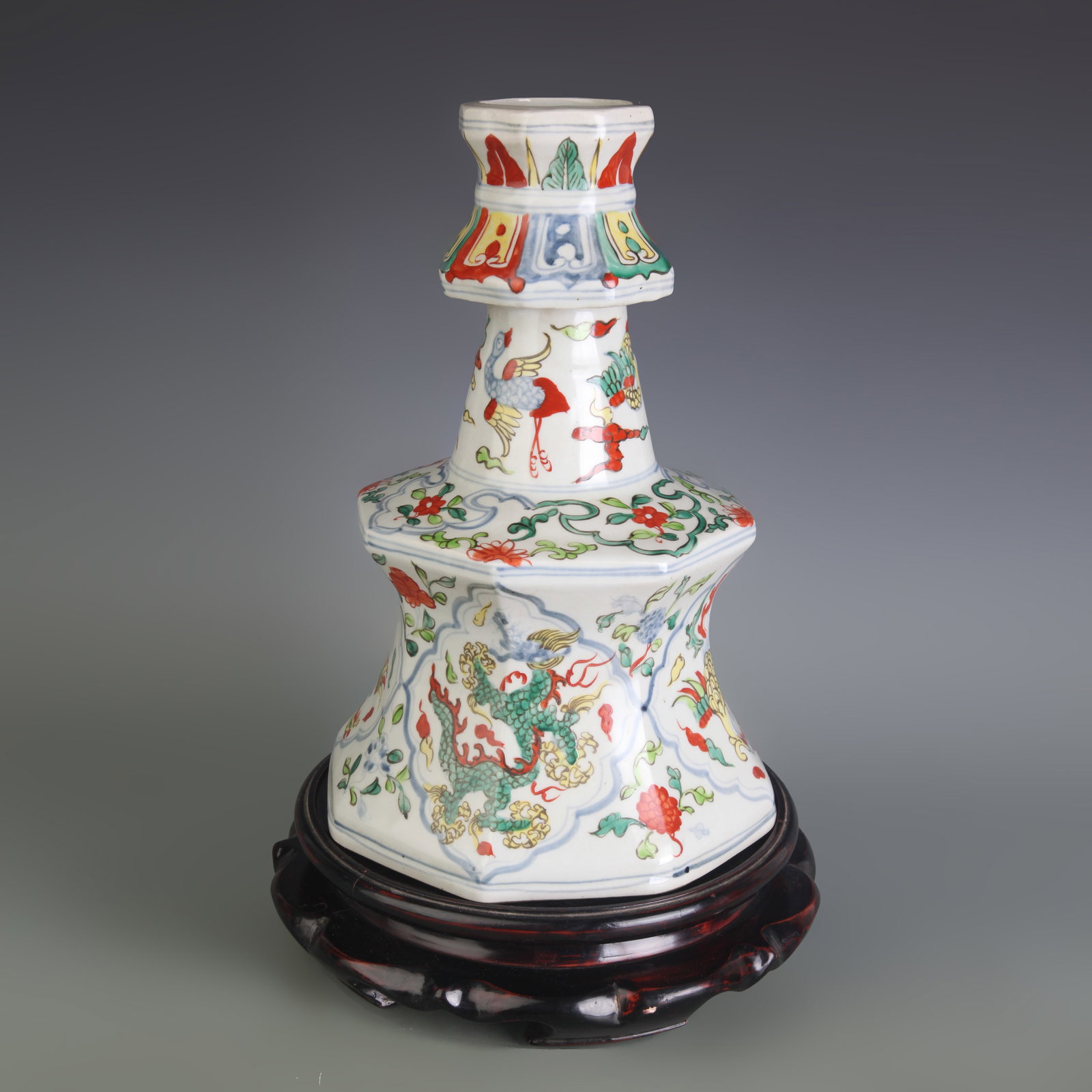A PAIR OF WUCAI CANDLESTICKS WITH DRAGON AND PHOENIX MOTIFS: Ming Dynasty Style; Width: 8.0 inch; High: 12.0 inch; Wooden base for picture and display only.