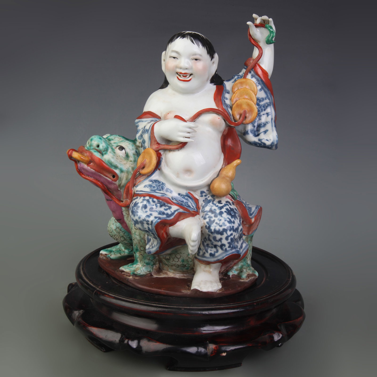 A FAMILLE ROSE FIGURE OF LIU HAI WITH THE THREE-LEGGED TOAD: Republic Period; High: 10.2 inch; Wooden base for picture and display only.