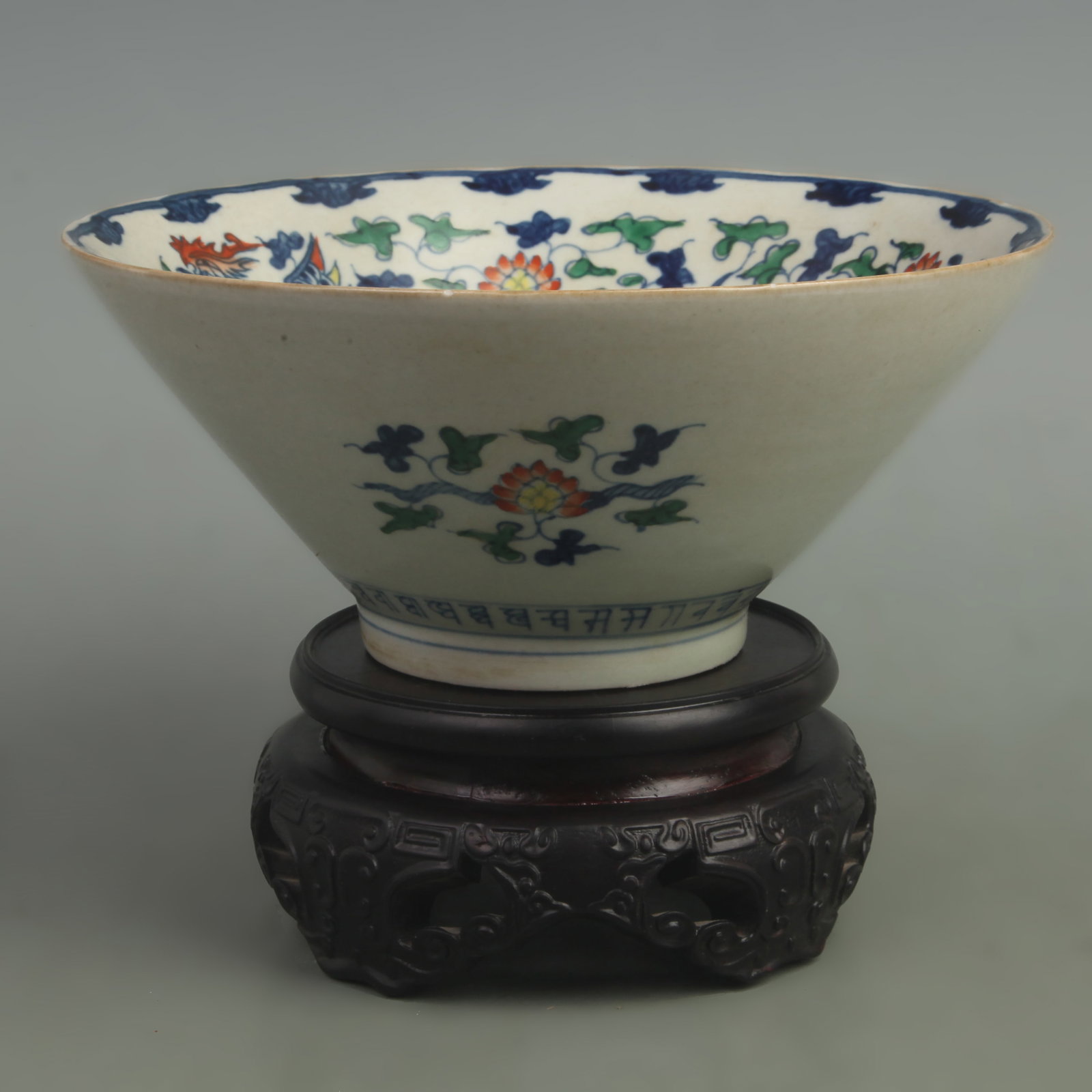 A FINE DOUCAI PHOENIX AND FLOWER MOTIF PORCELAIN BOWL: Ming Dynasty Style Wang Li Period, High: 3.8 inch; Diameter: 8.5 inch. Wooden base for picture and display only.