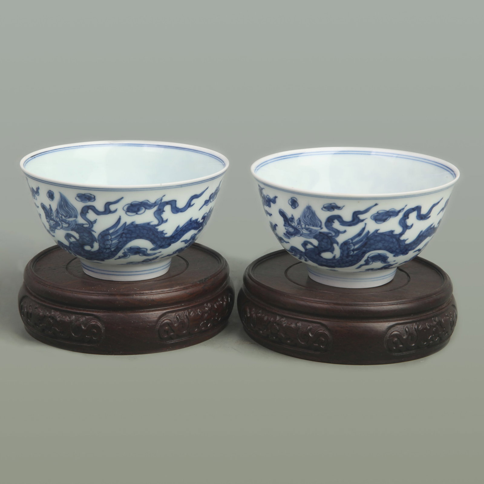 PAIR OF BLUE AND WHITE SMALL BOWLS WITH DRAGON MOTIFS: Ming Dynasty Style, High: 1.8 inch; Diameter: 3.6 inch. Wooden base for picture and display only.