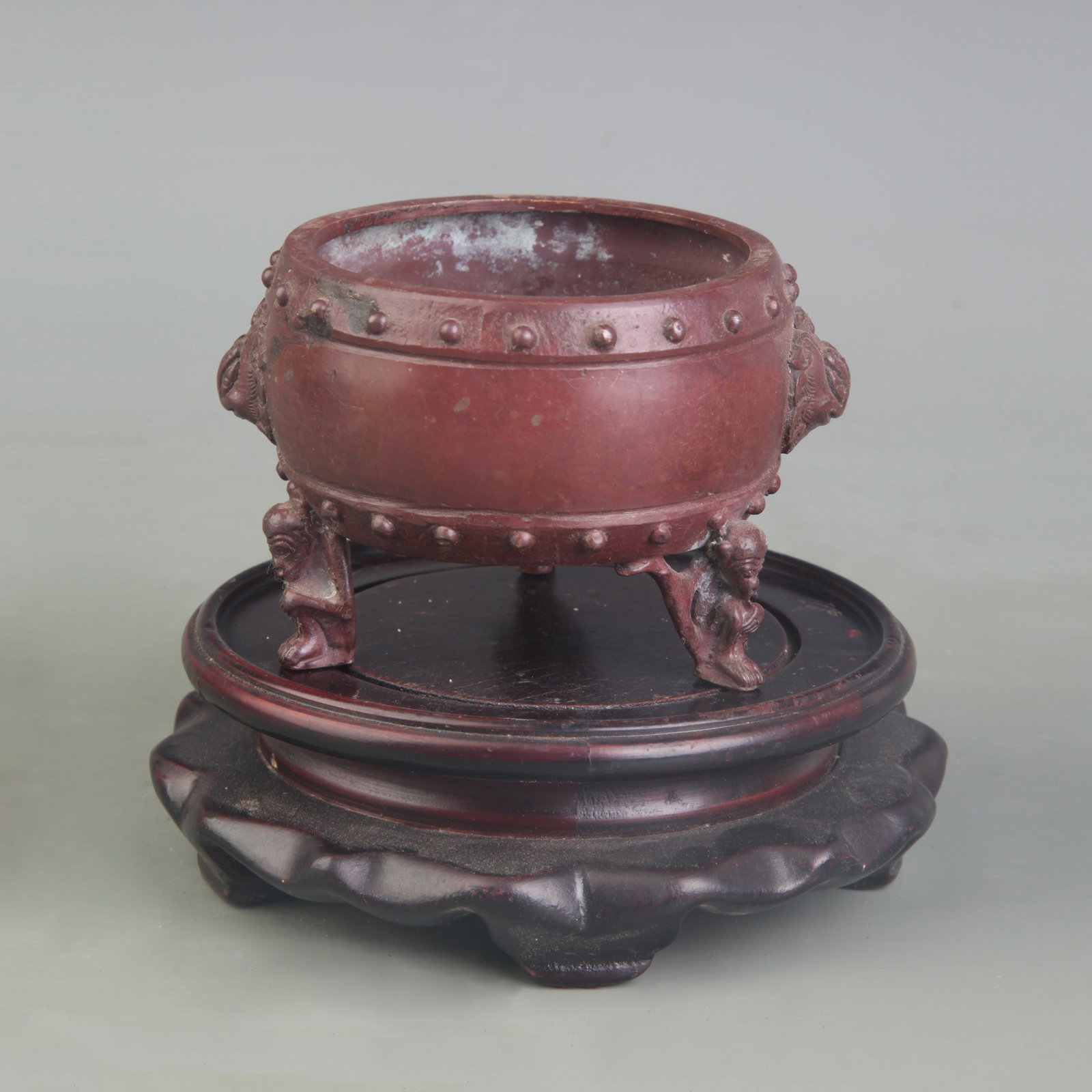 A TRIPOD CENSER WITH ANIMAL-HEAD HANDLES: 19th Century; Diameter: 3.1 inch; High: 2.5 inch; Wooden base for picture and display only.