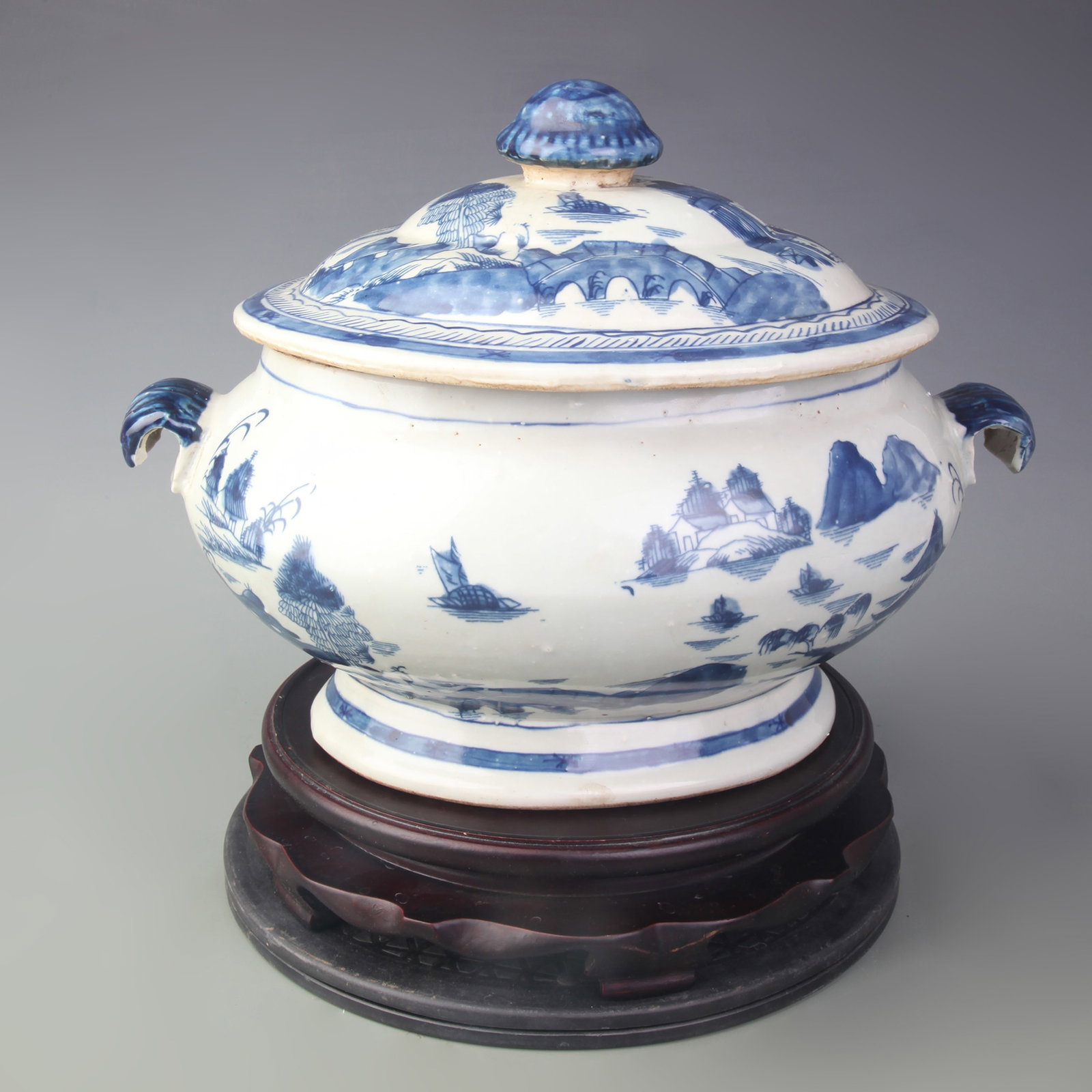 BLUE-AND-WHITE LANDSCAPE PATTERN DOUBLE-EARED LARGE JAR: Qing Dynasty; Long: 14.5 inch; High: 10.6 inch. Wooden base for picture and display only.