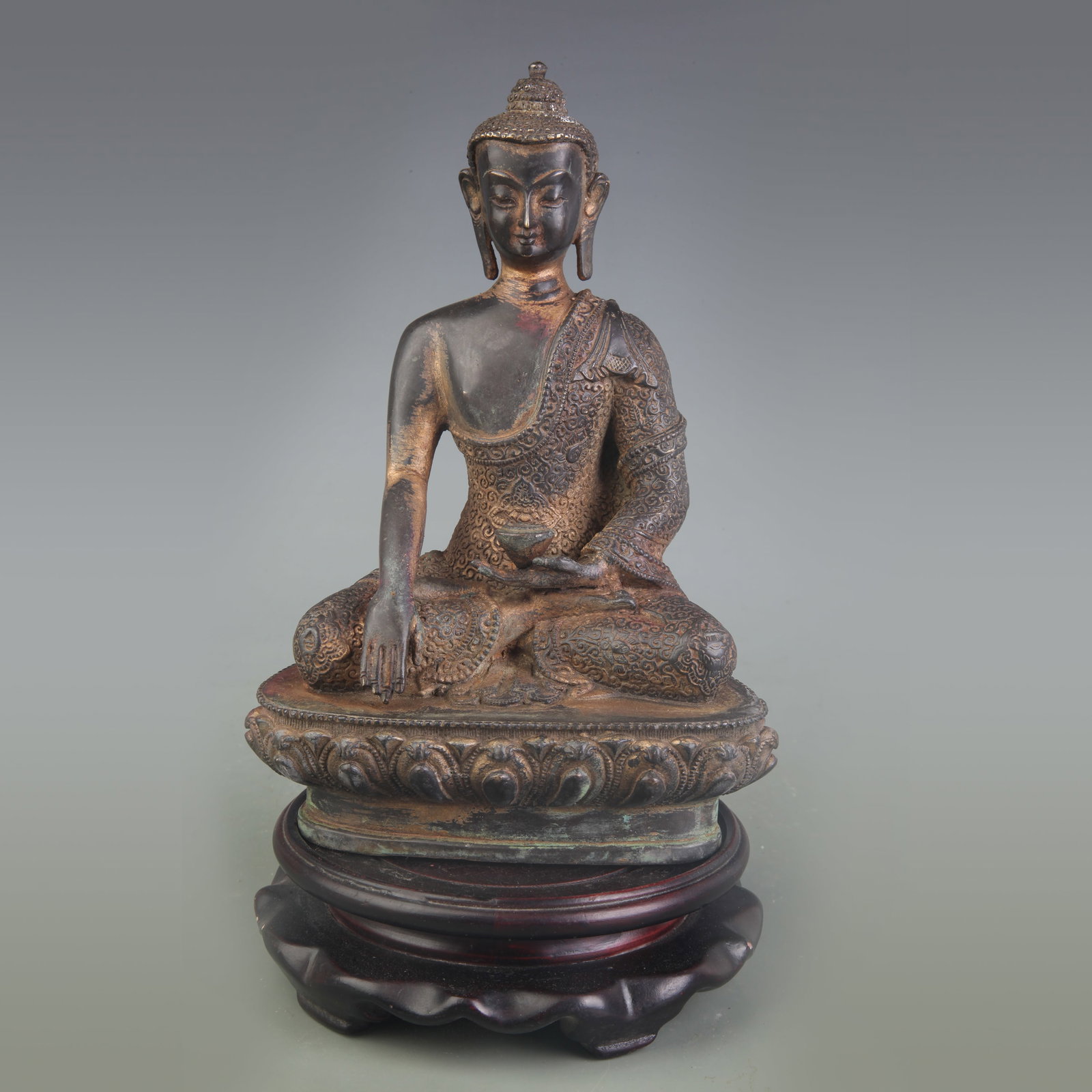 A BRONZE FIGURE OF MEDICINE BUDDHA: 18th Century; Width: 5.0 inch; High: 7.5 inch; Wooden base for picture and display only.
