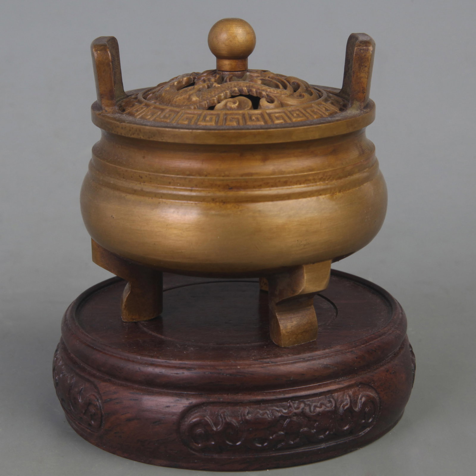 A FINE DRAGON CARVING THREE FOOT INCENSE BURNER: Ming Dynasty, Diameter: 2.9 inch High: 3.0 inch; Wooden base for picture and display only.