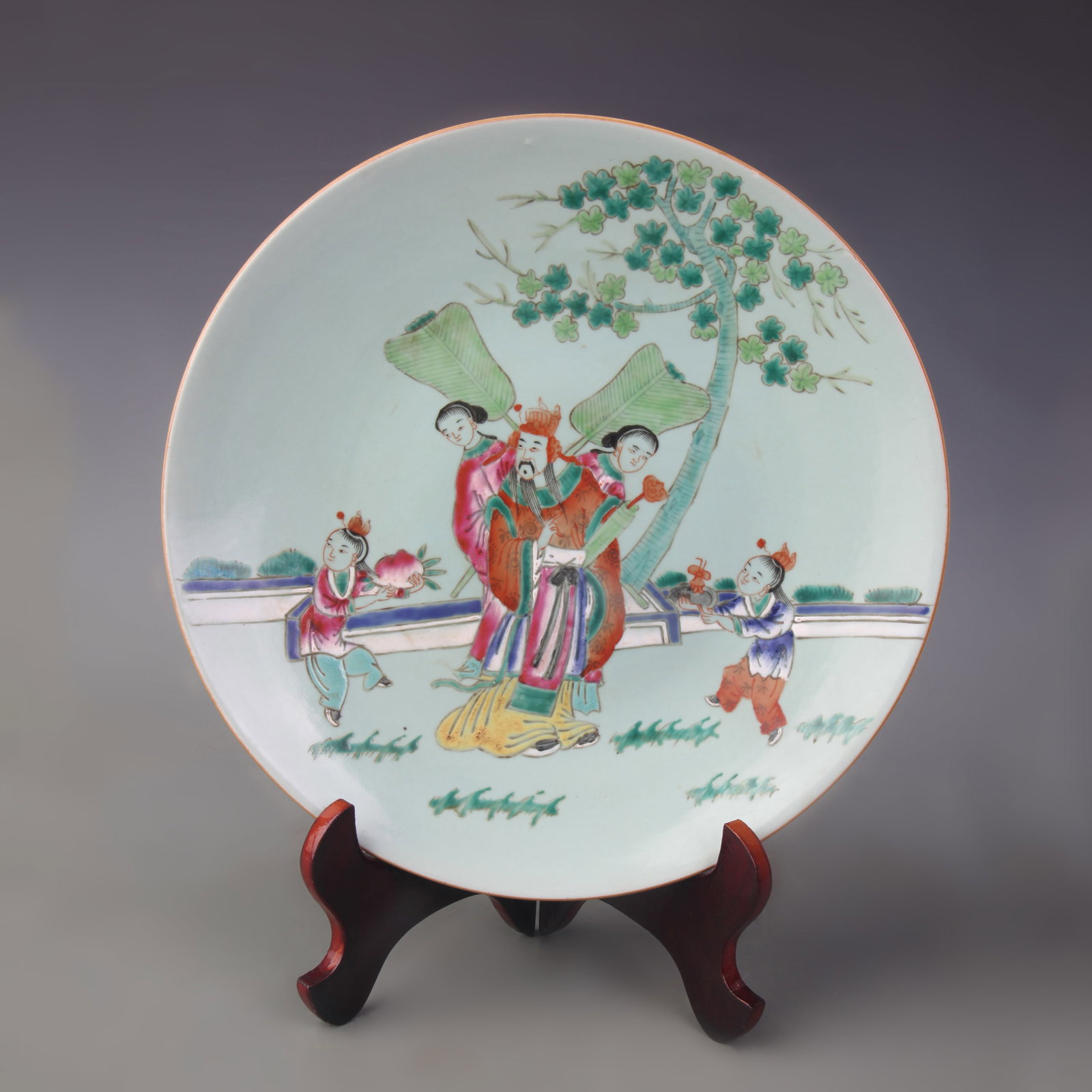 A FAMILLE ROSE DISH WITH FIGURAL DECORATION: Qing Dynasty; Diameter: 11.0 inch; Wooden base for picture and display only.