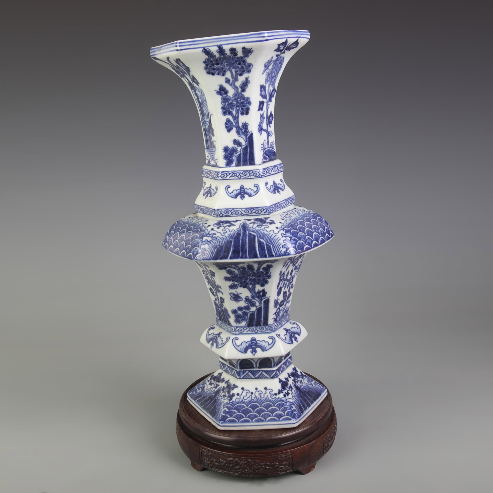 BLUE-AND-WHITE BAT AND FLOWER PATTERN HEXAGONAL PORCELAIN VASE: Ming Dynasty Style; High: 14.2 inch; Diameter: 5.9 inch; Wooden base for picture and display only.