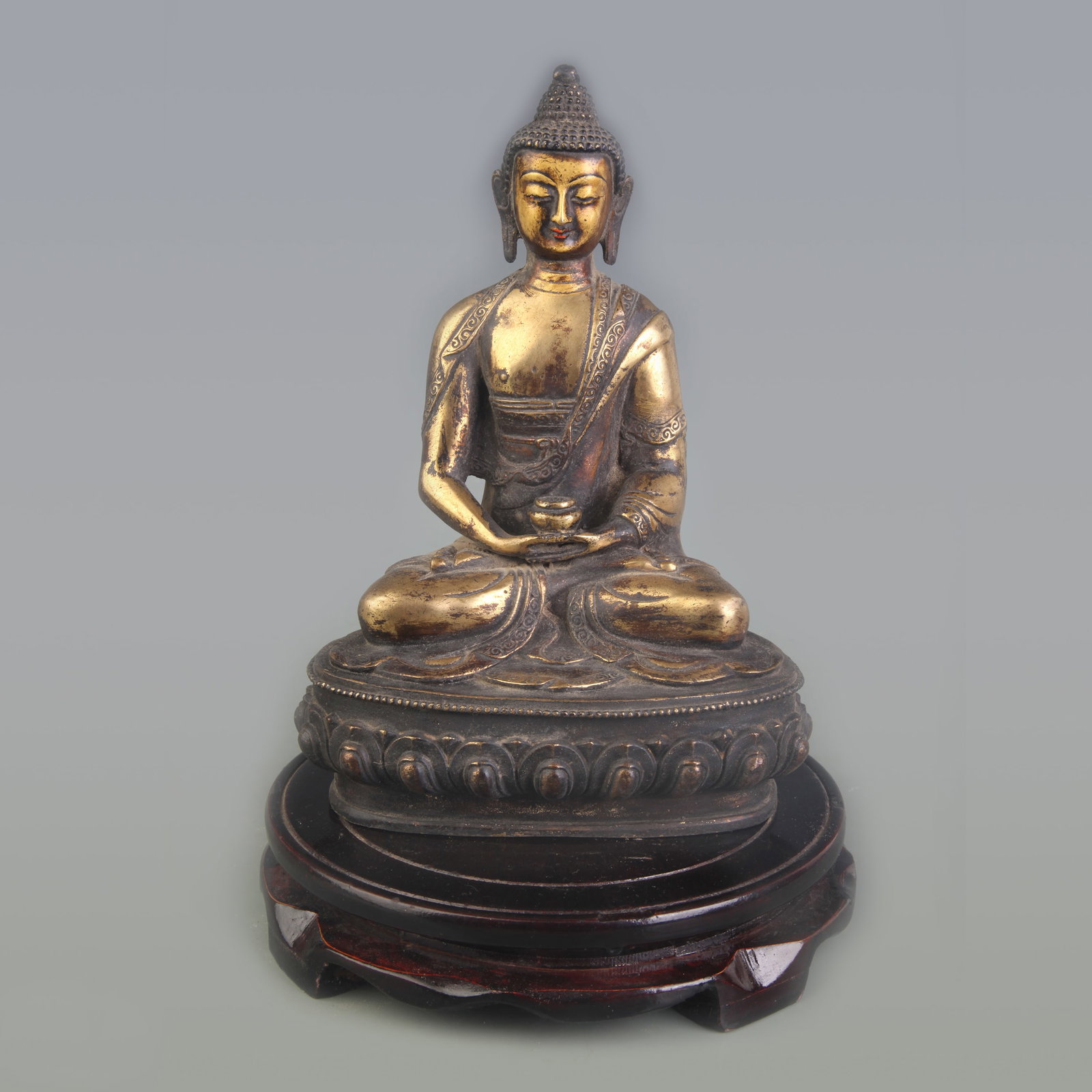A FINE BRONZE BUDDHA OF INFINITE LIFE: Qing Dynasty; Width: 5.5 inch; High: 8.1 inch. Wooden base for picture and display only.