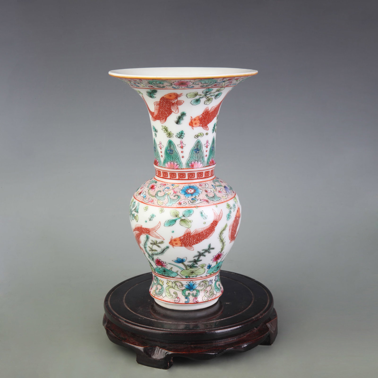 FAMILLE ROSE PORCELAIN VASE WITH FLORAL MOTIFS: Qing Dynasty Qian Long Period; Diameter: 5.8 inch; High: 9.0 inch. Wooden base for picture and display only.