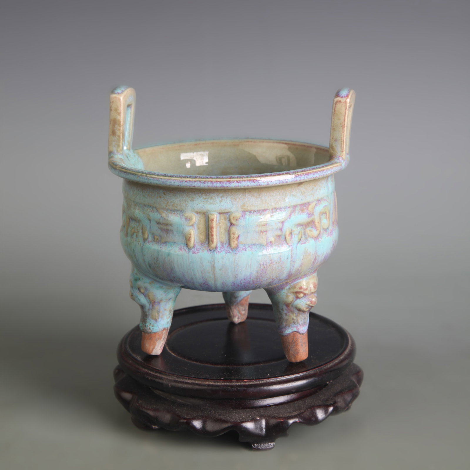 A FINE JUN WARE TRIPOD PORCELAIN INCENSE BURNER: Qing Dynasty; Diameter: 4.7 inch; High: 5.2 inch. Wooden base for picture and display only.