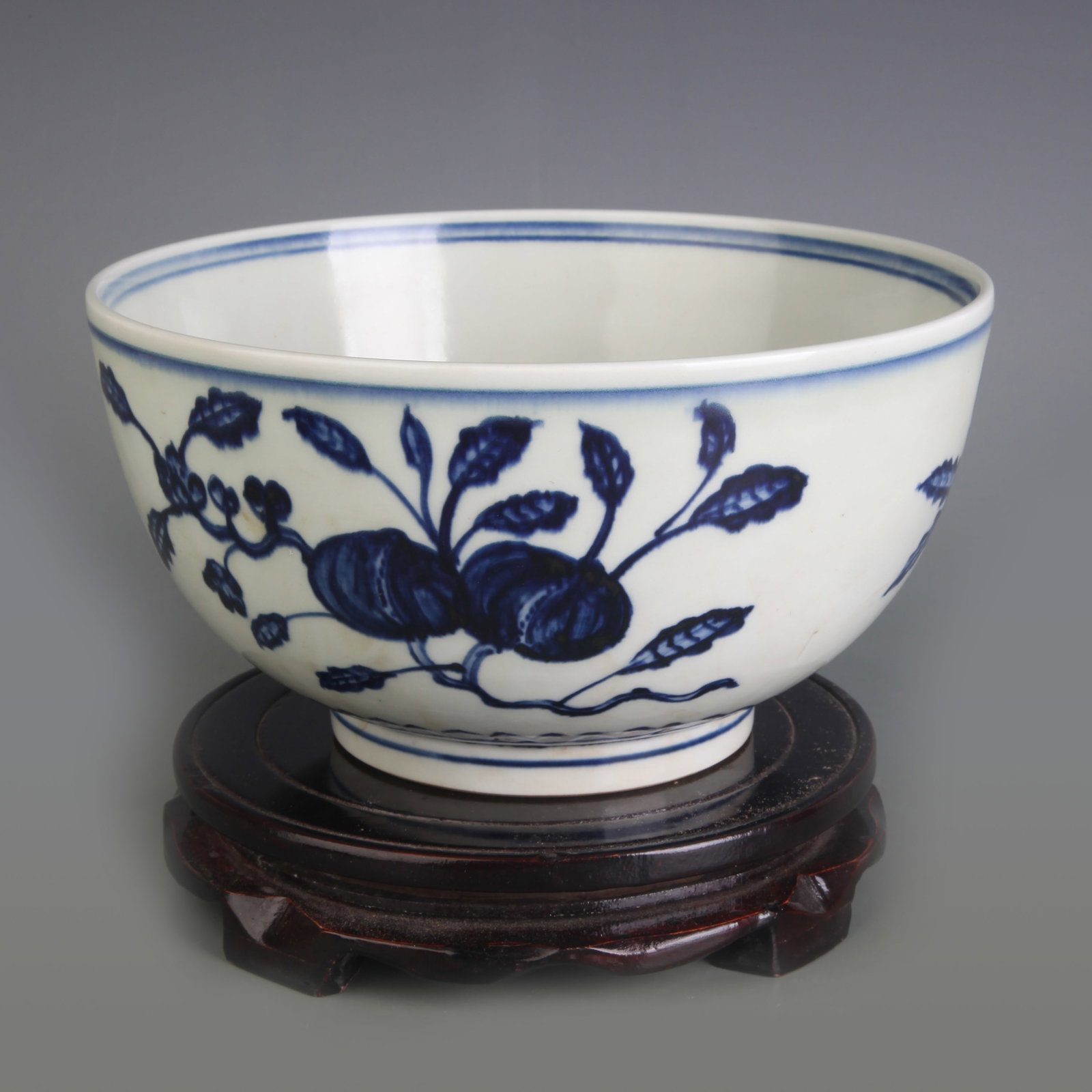 A BLUE AND WHITE BOWL WITH FLORAL SPRAYS: Qing Dynasty; Diameter: 8.2 inch; High: 4.4 inch; Wooden base for picture and display only.