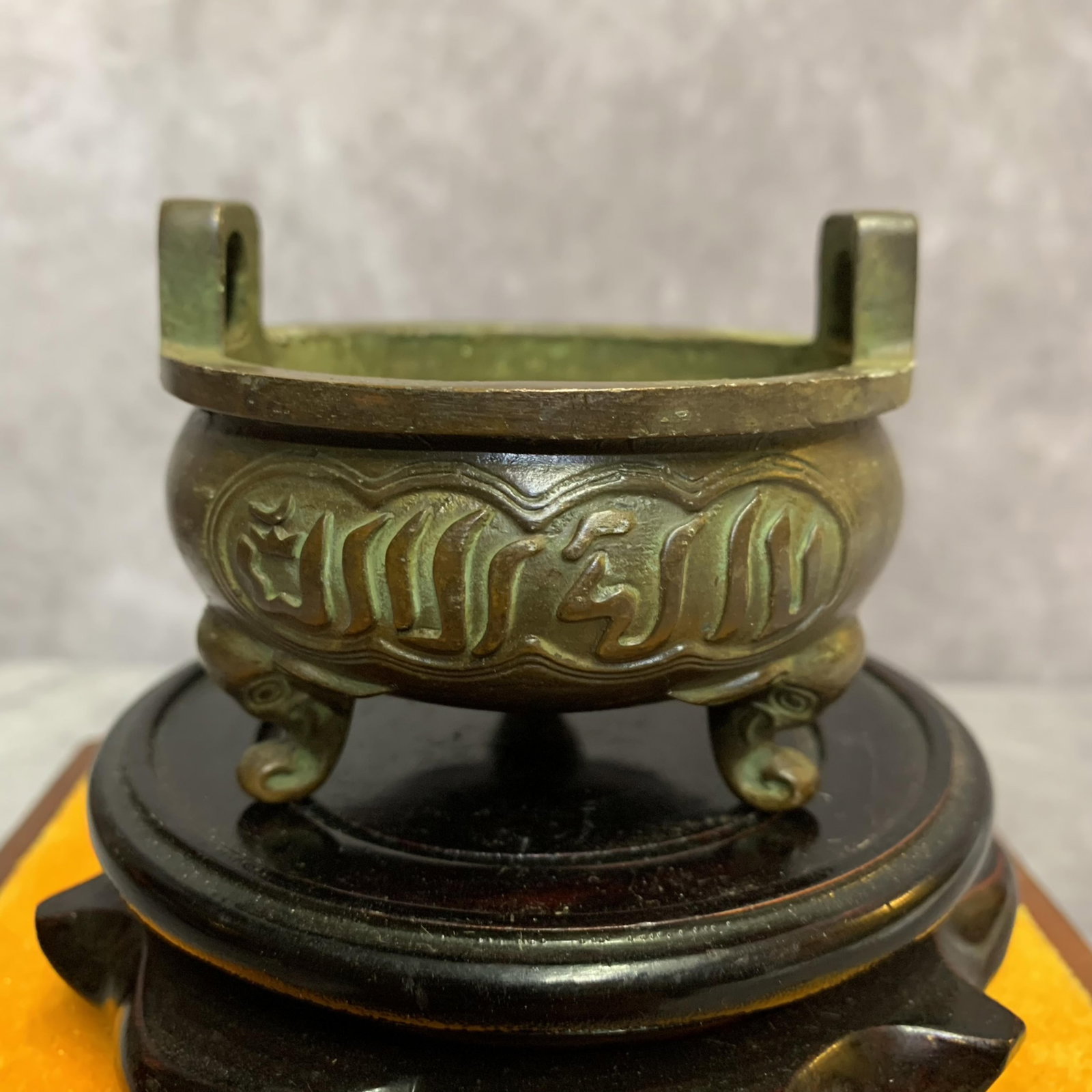 A FINE SANSKRIT-INSCRIBED THREE-LEGGED ROUND BRONZE CENSER: 19th Century; High: 3.4 inch; Width: 3.0 inch; Diameter: 3.0 inch; Wooden base for picture and display only.
